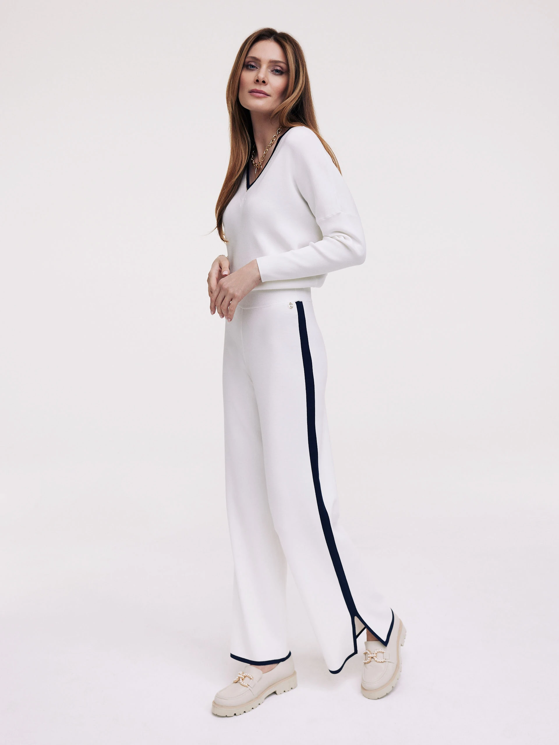 White pants with navy blue piping