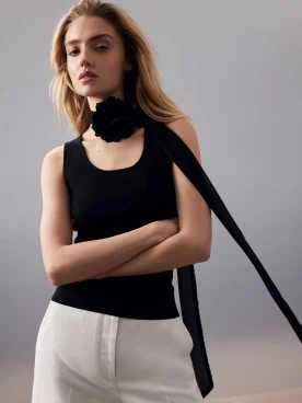 Black fabric necklace with a flower-shaped pendant