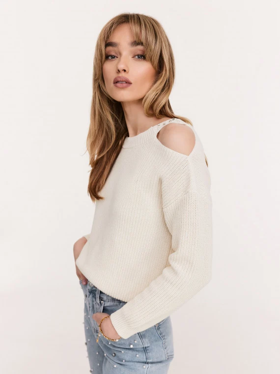 Cream sweater with striking cutouts