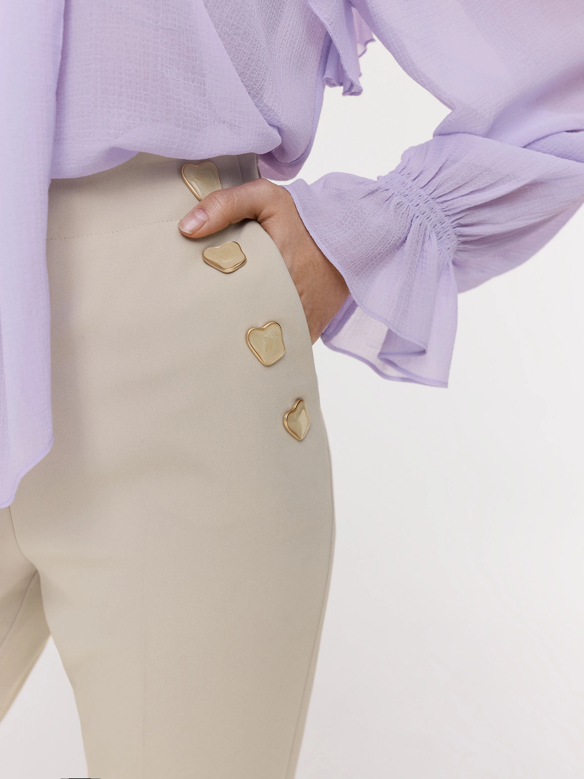 Beige cigarette pants with decorative buttons