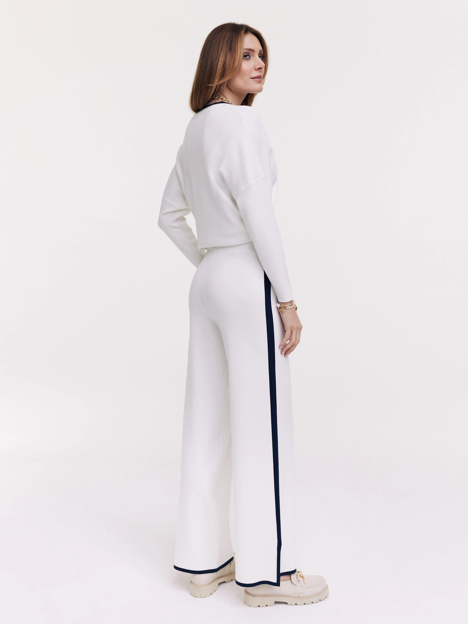 White pants with navy blue piping