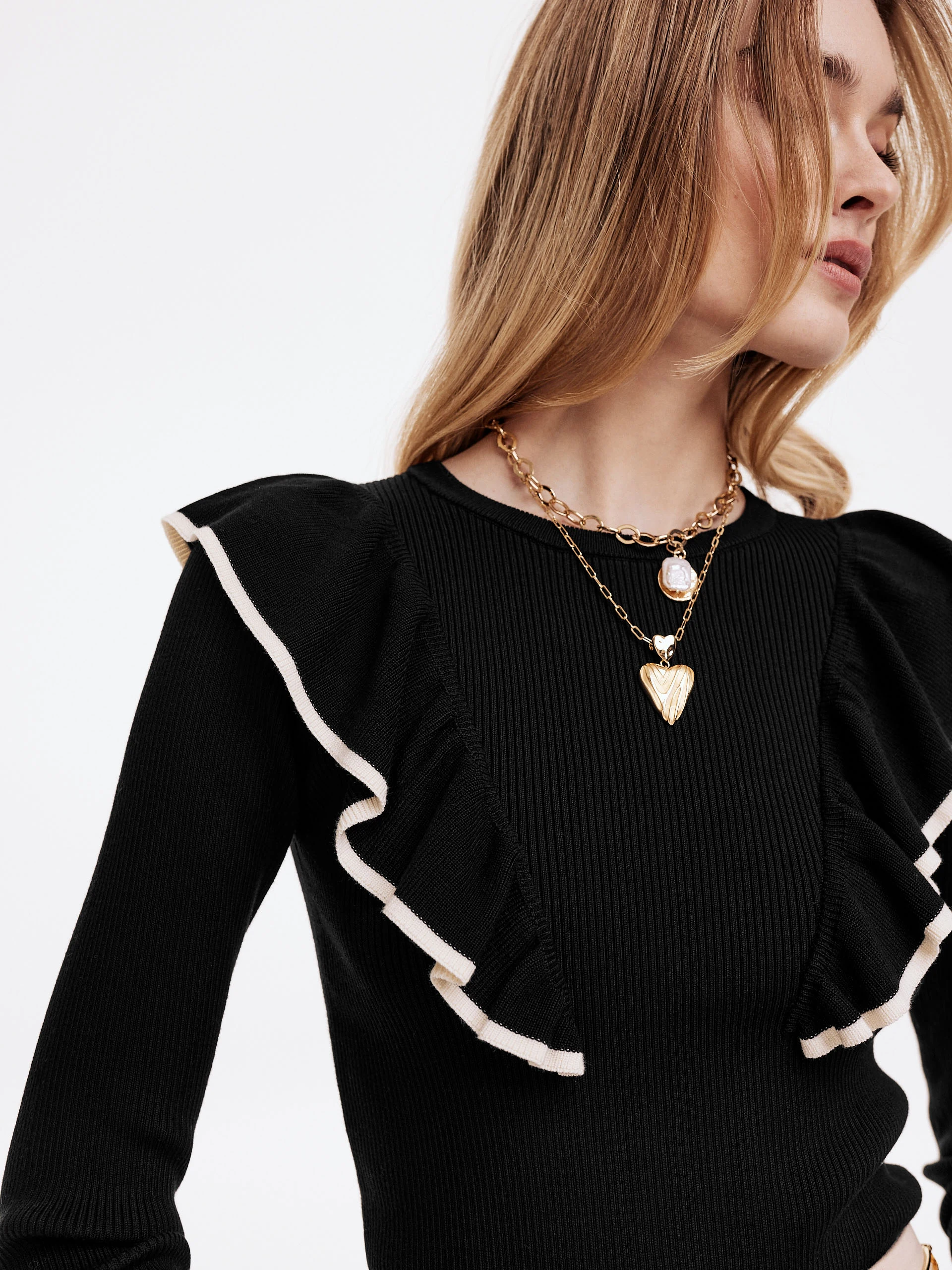 Black sweater with decorative ruffles