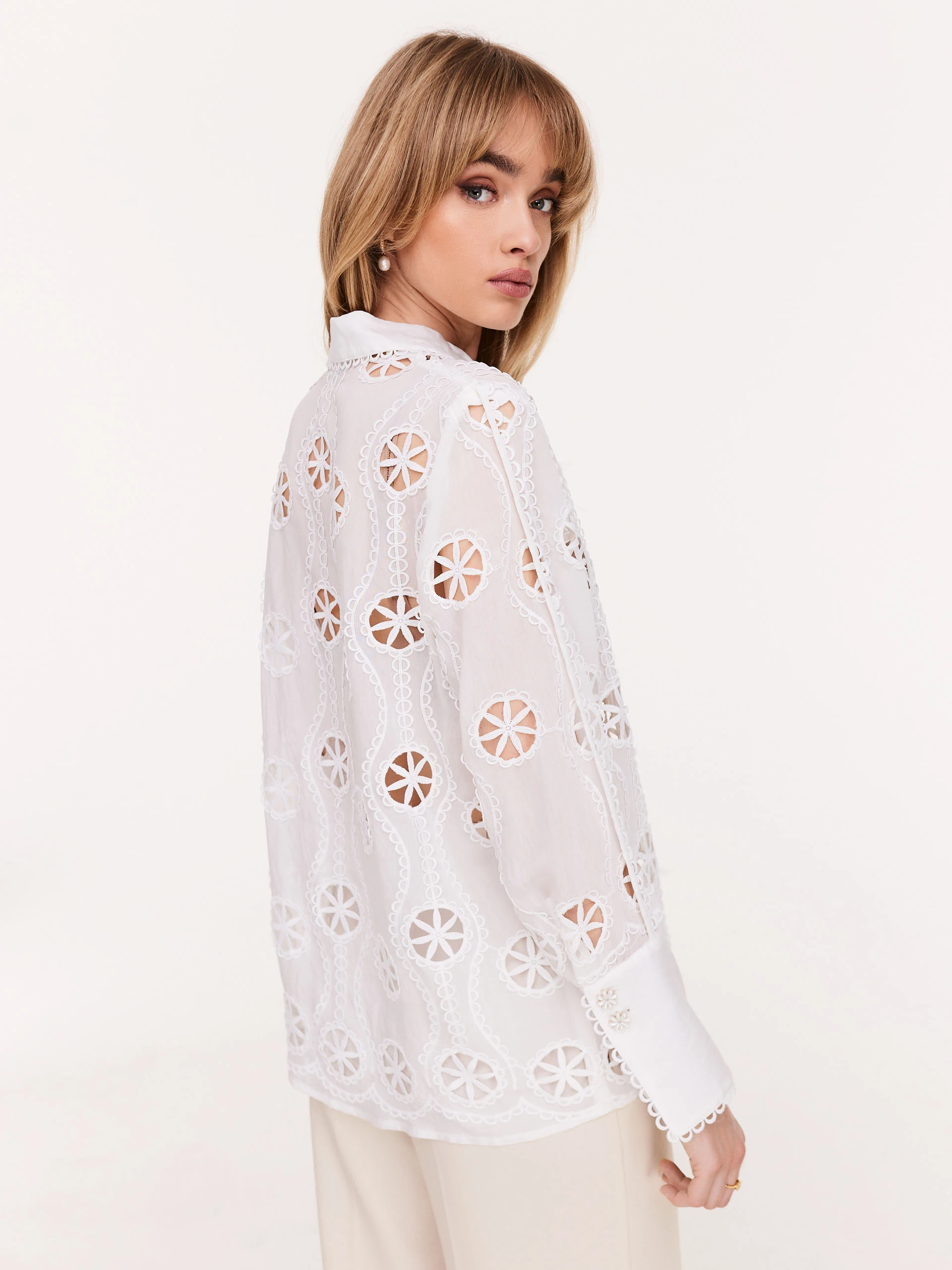 Openwork white shirt with daisy-shaped buttons