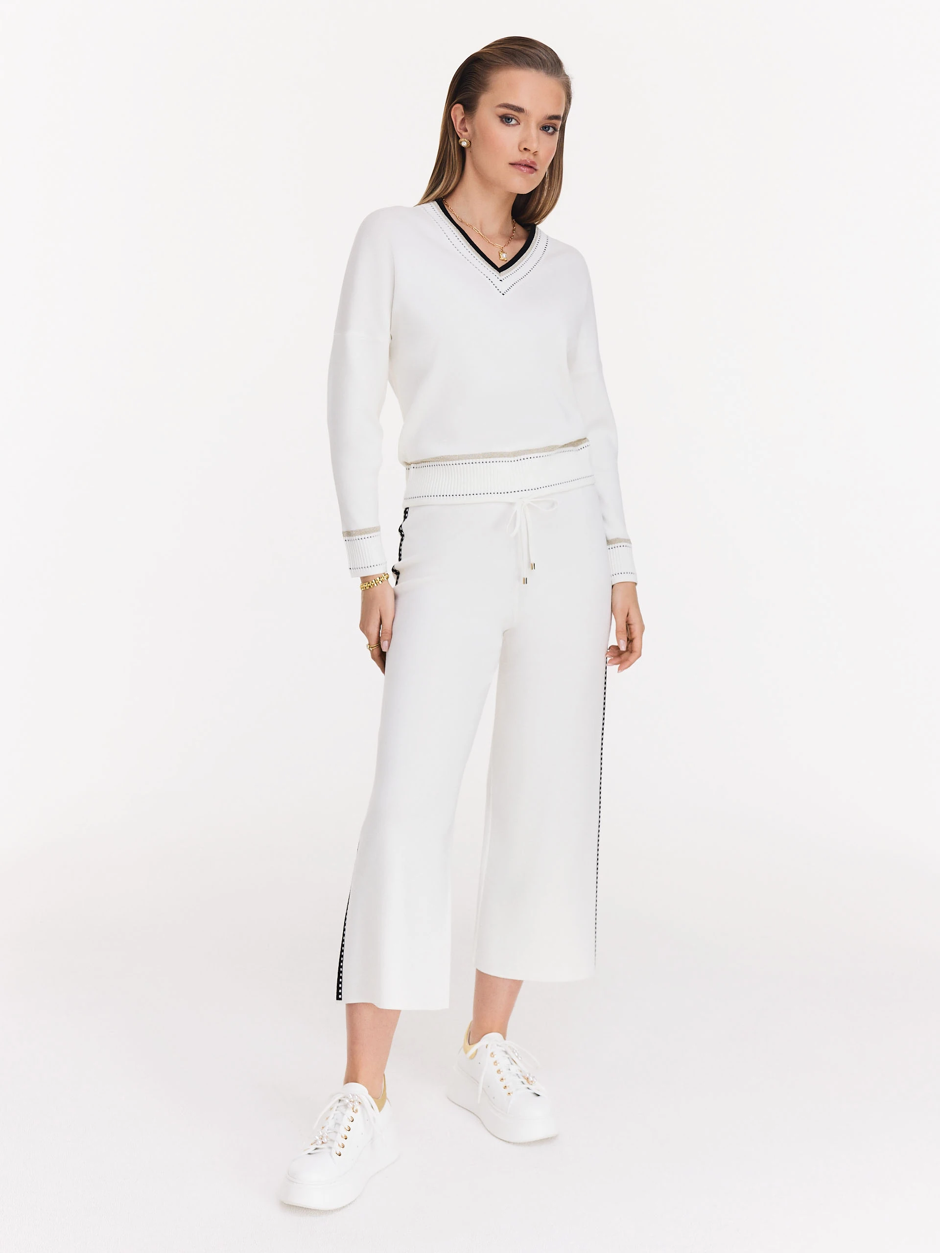 Cream high-waisted pants with black piping