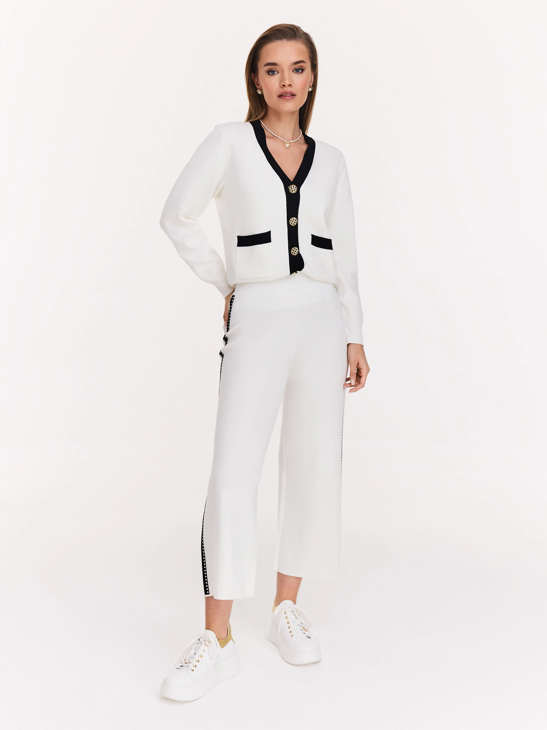 Cream high-waisted pants with black piping
