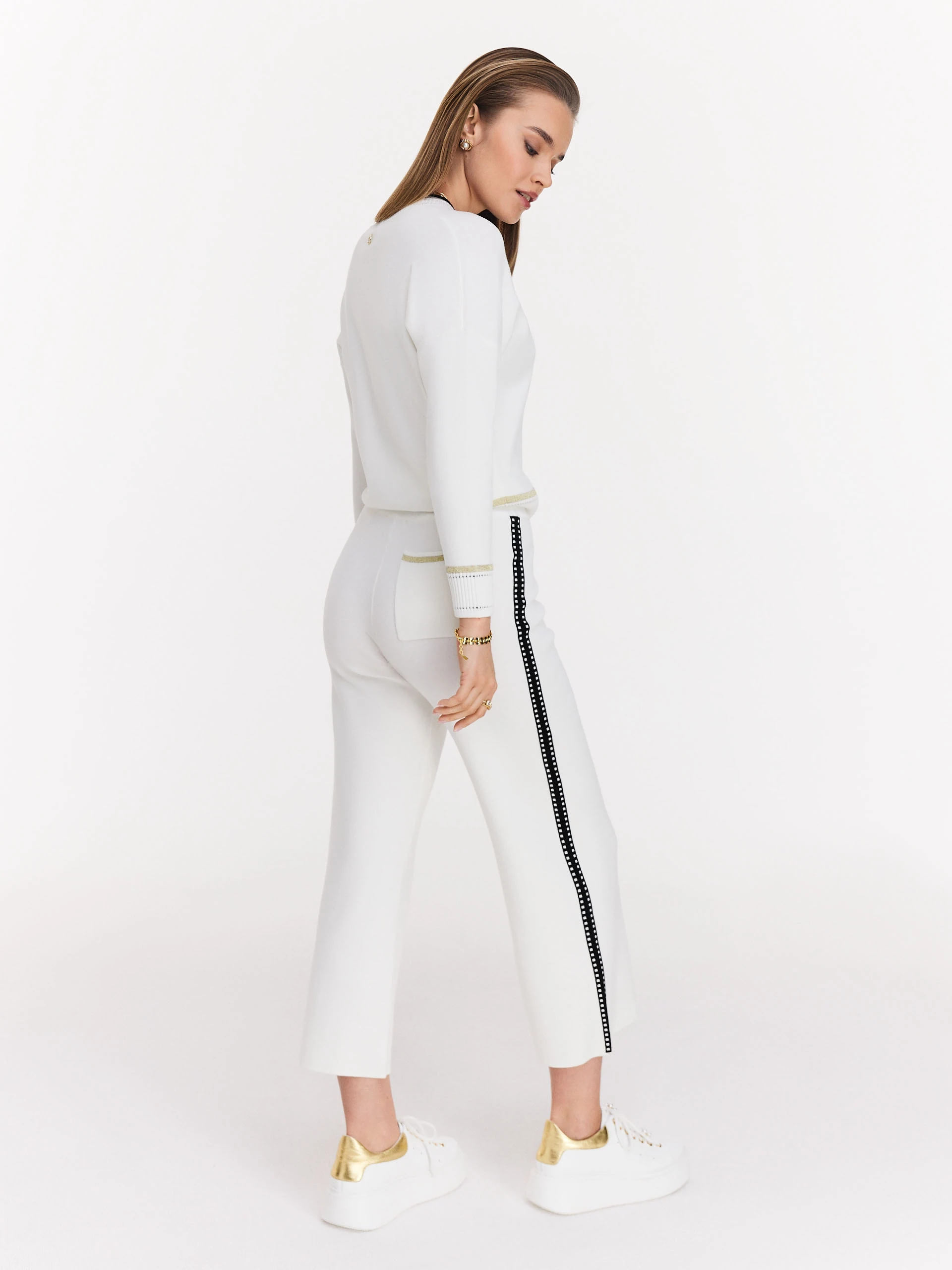 Cream high-waisted pants with black piping