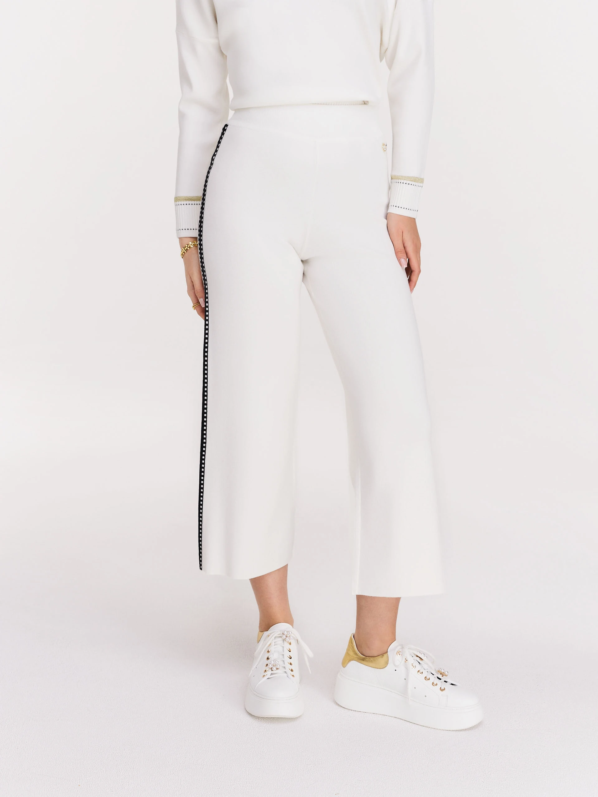 Cream high-waisted pants with black piping