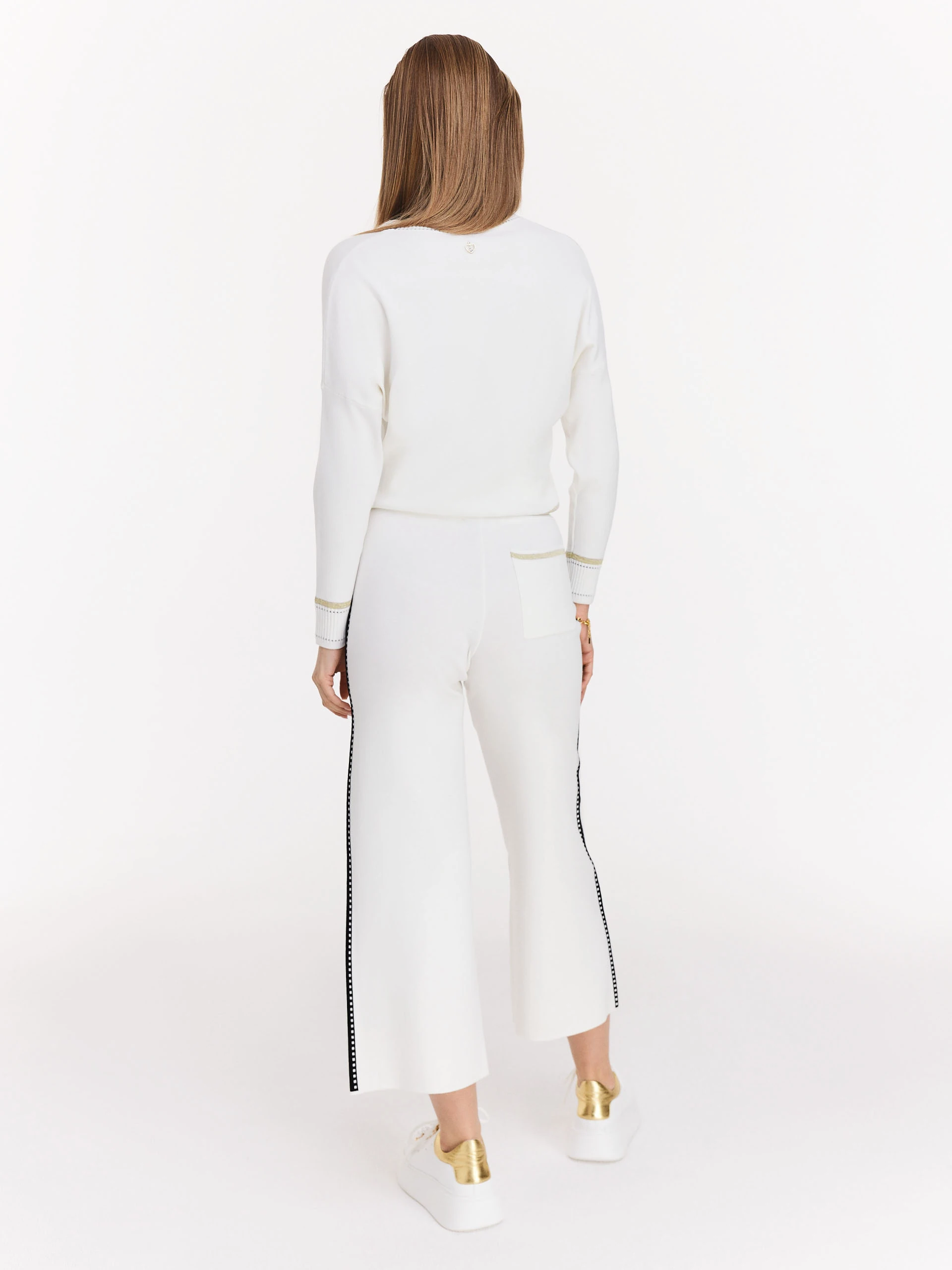 Cream high-waisted pants with black piping