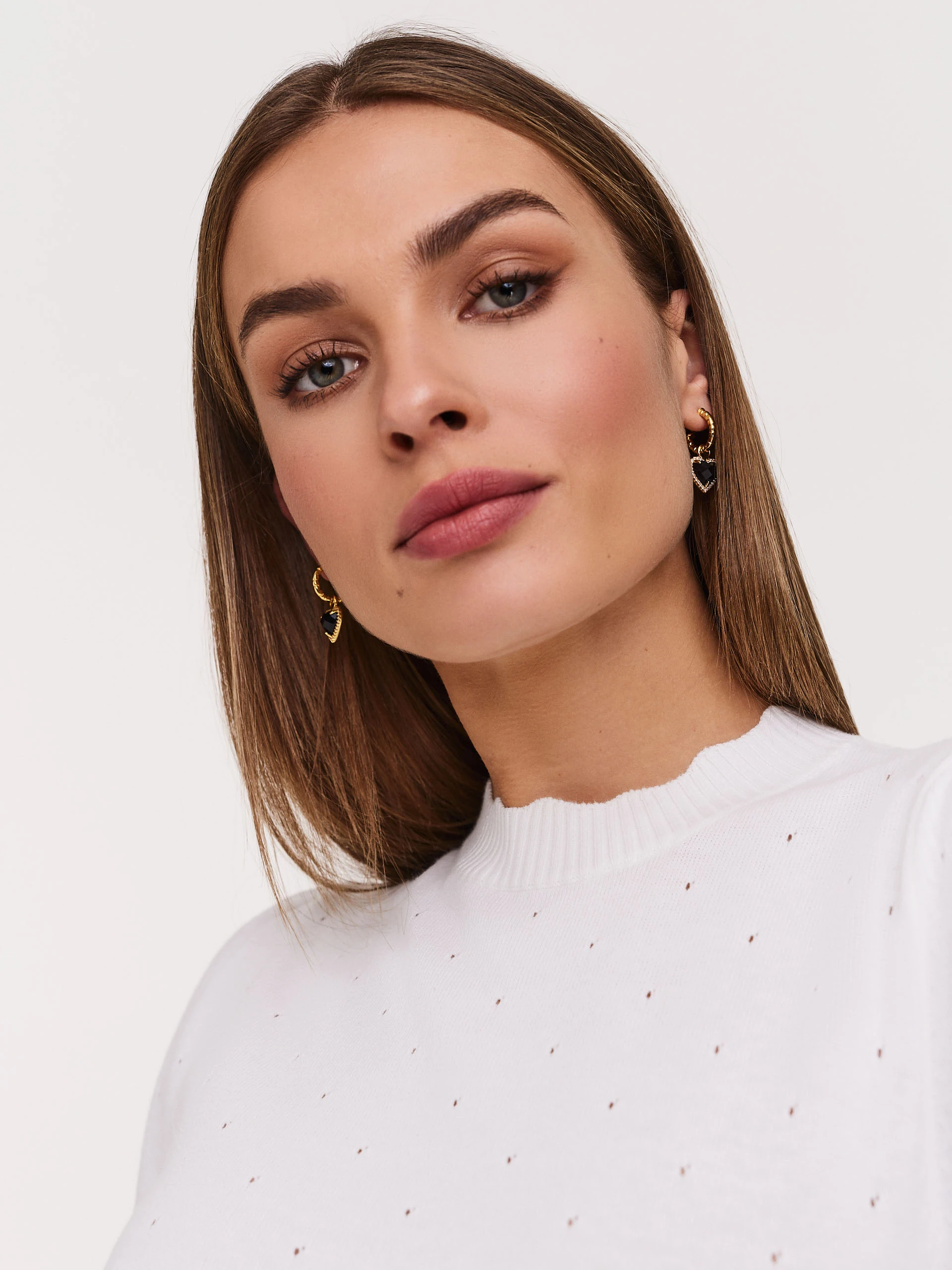 White buffet sweater with openwork embellishments