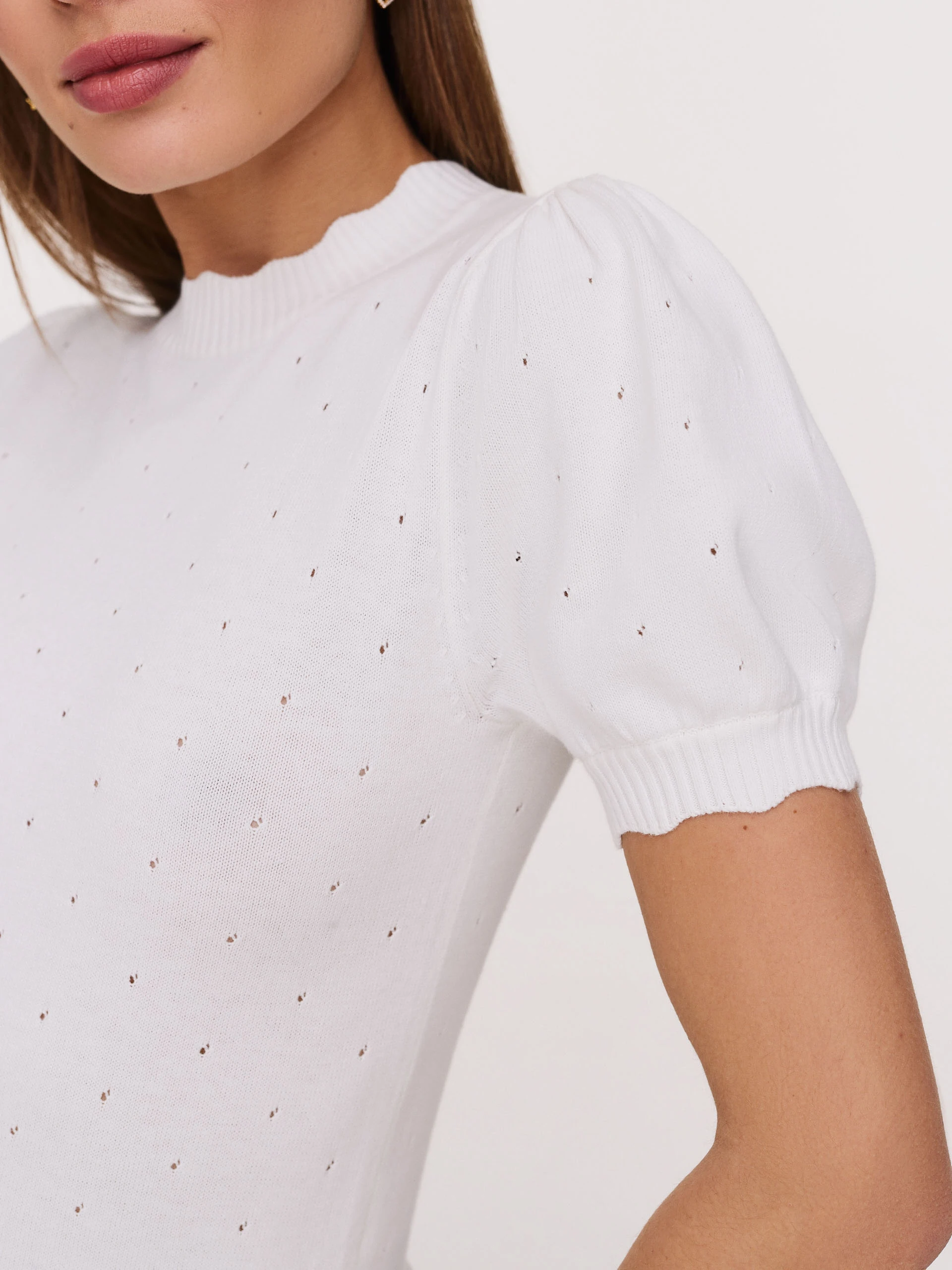 White buffet sweater with openwork embellishments