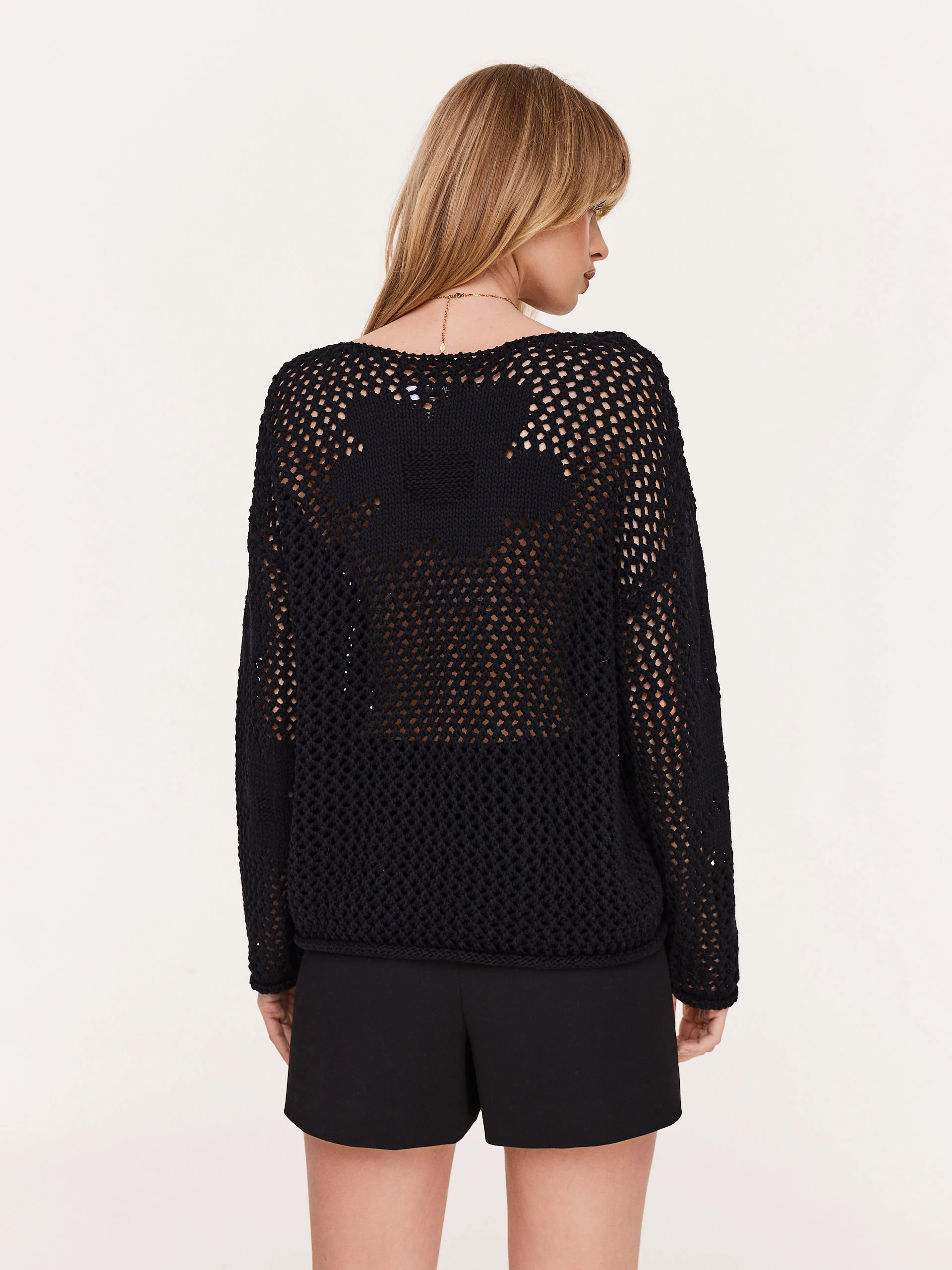Openwork black sweater with floral elements