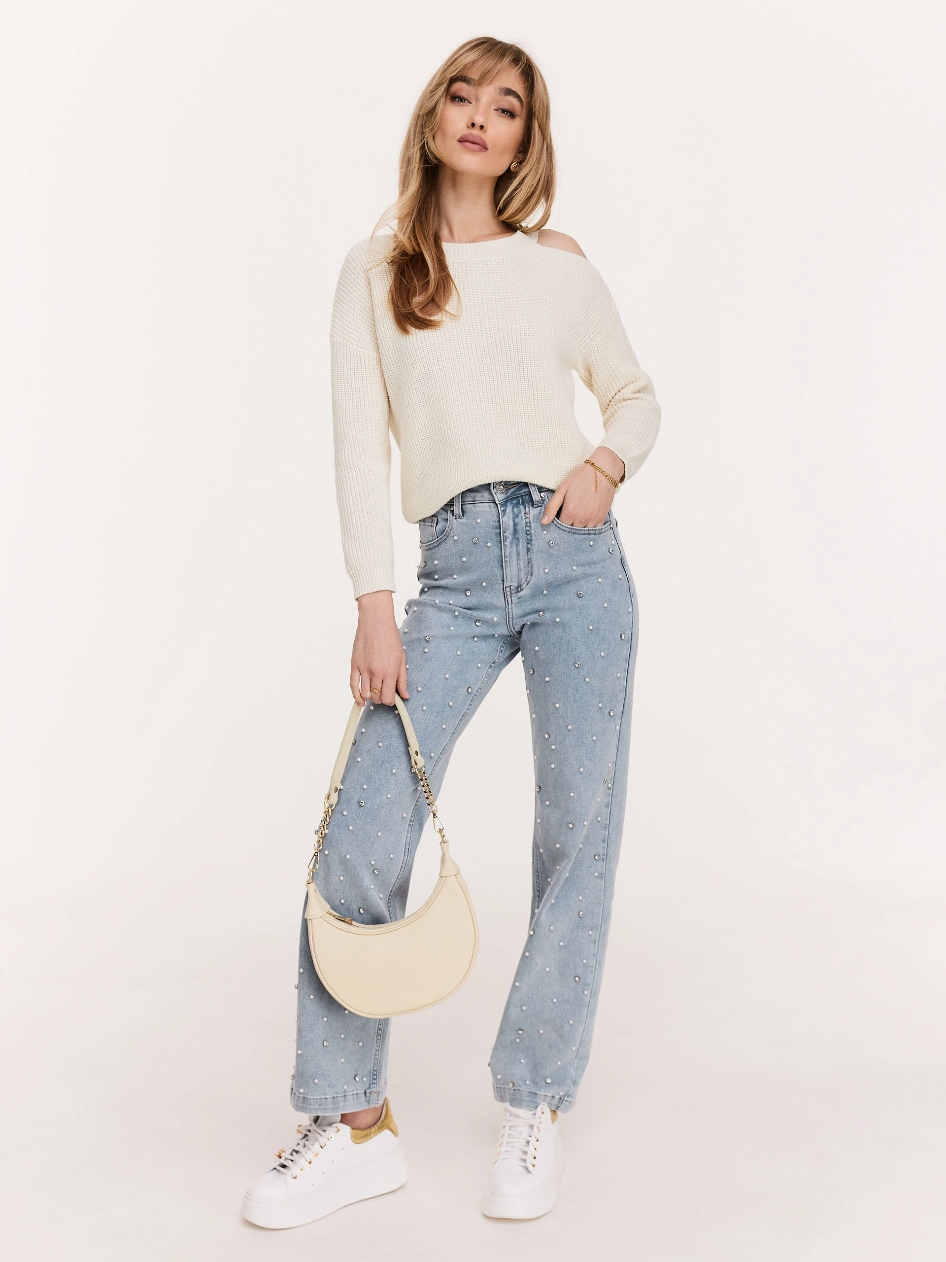 Cream sweater with striking cutouts