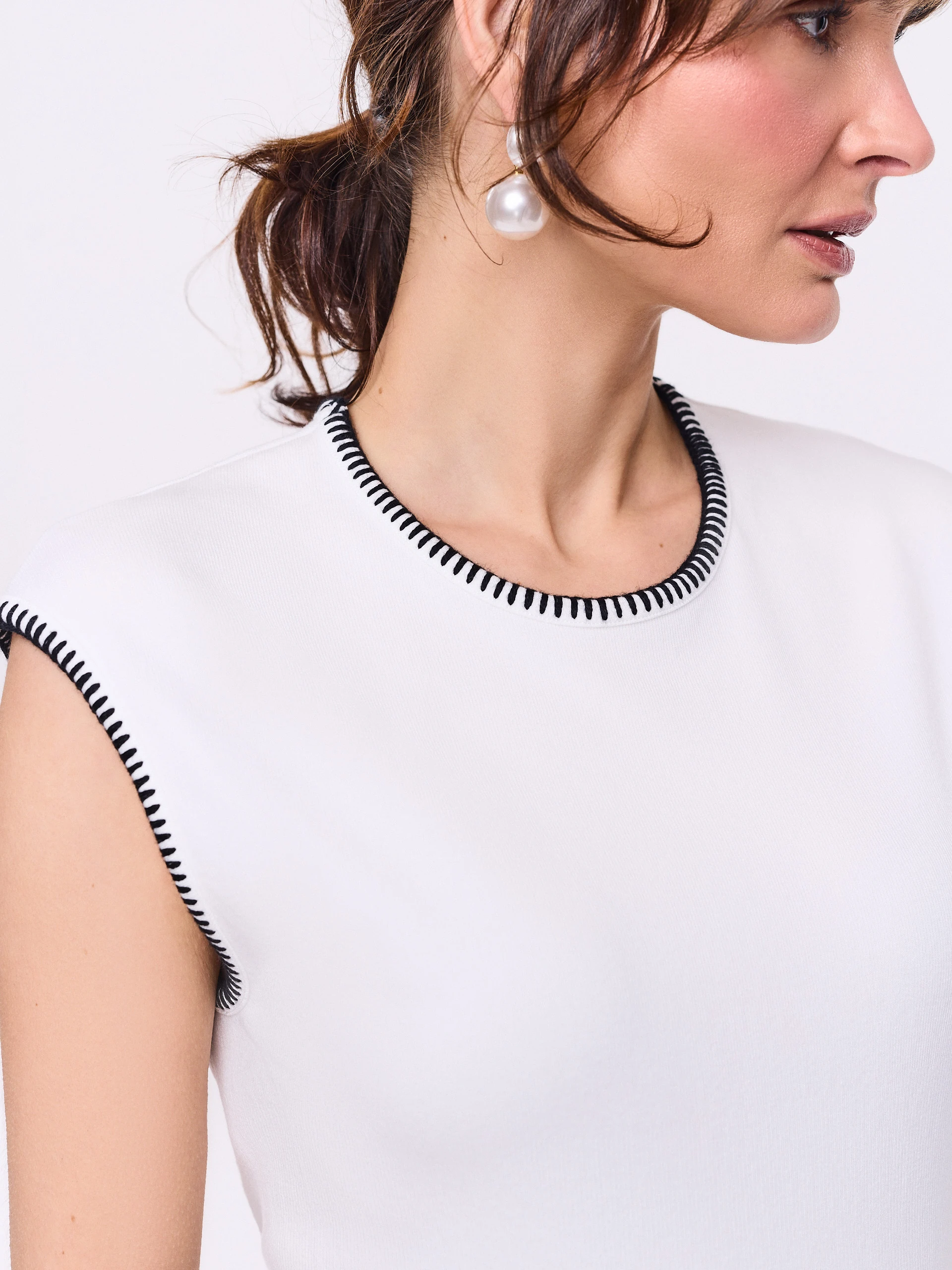 White sleeveless blouse with decorative trim