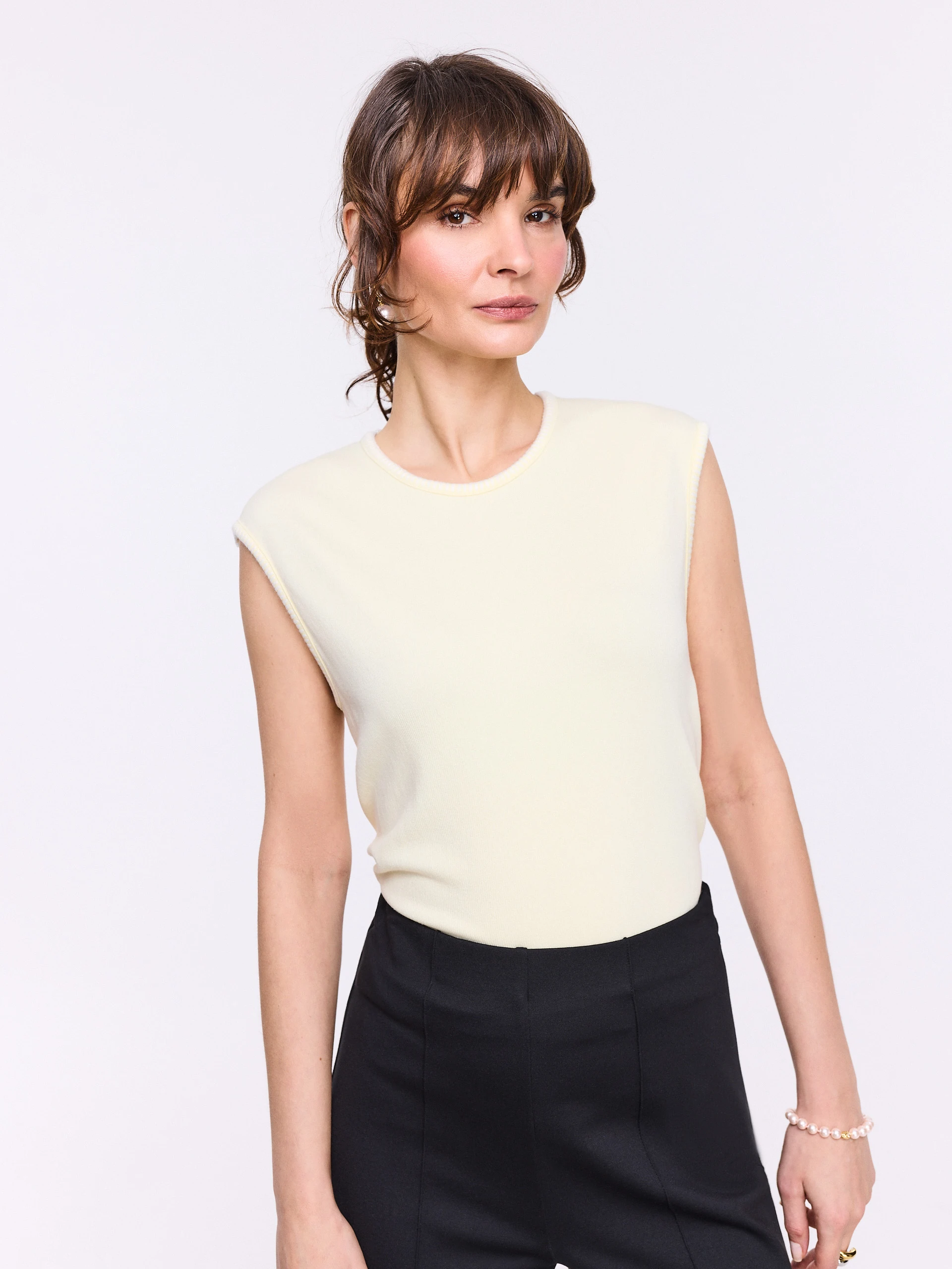 Light yellow sleeveless top with decorative trim