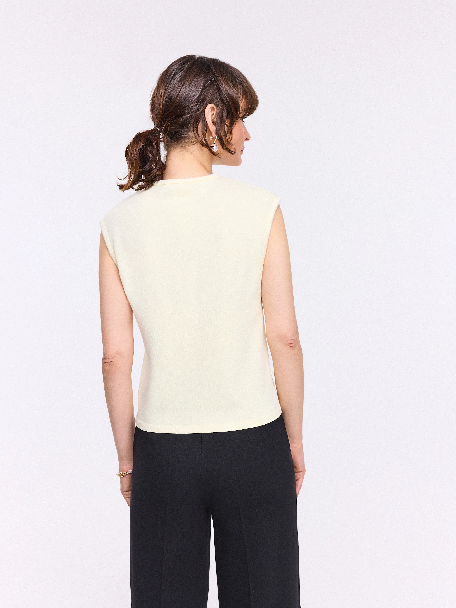 Light yellow sleeveless top with decorative trim