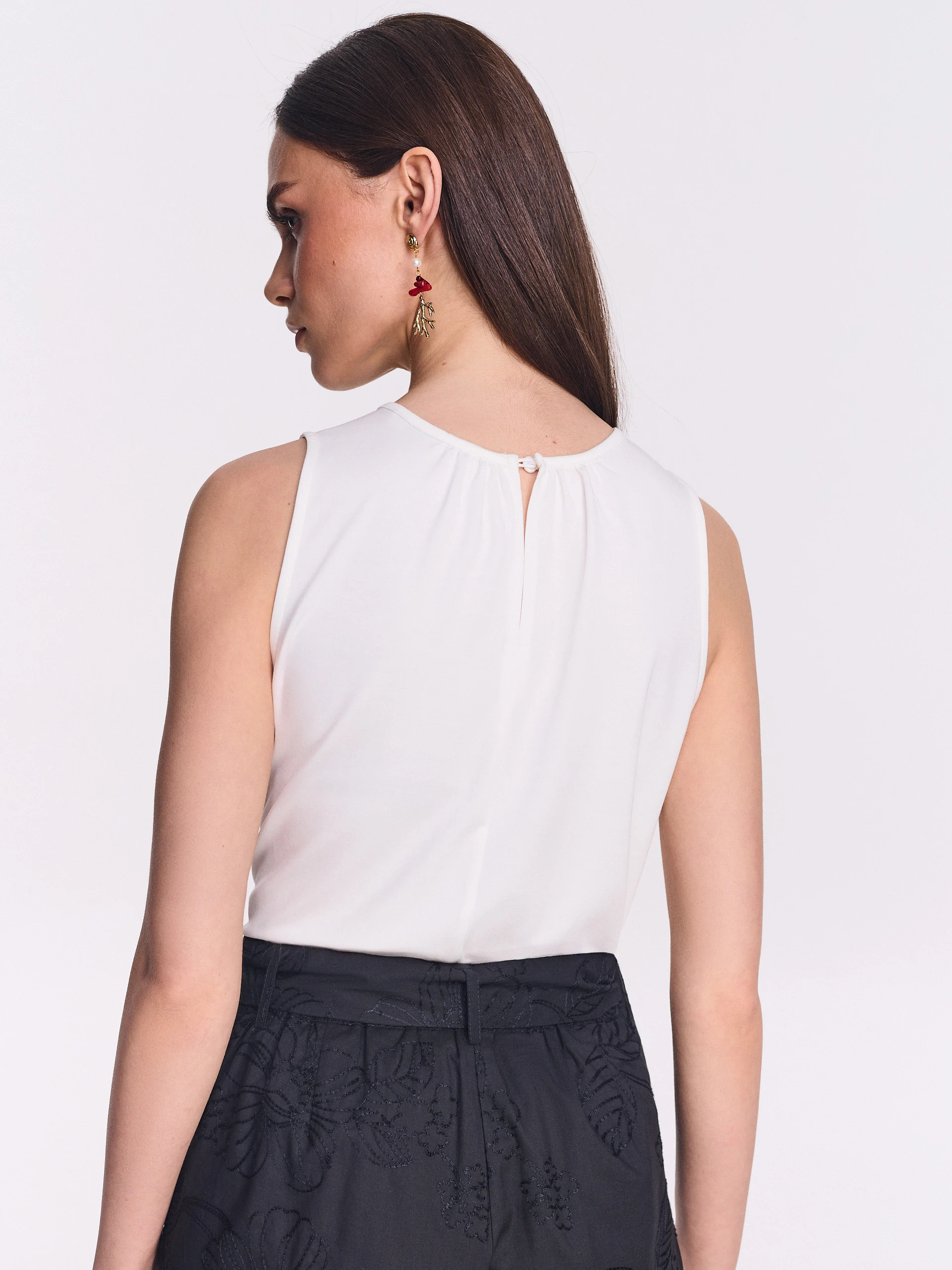 White blouse with floral appliqué