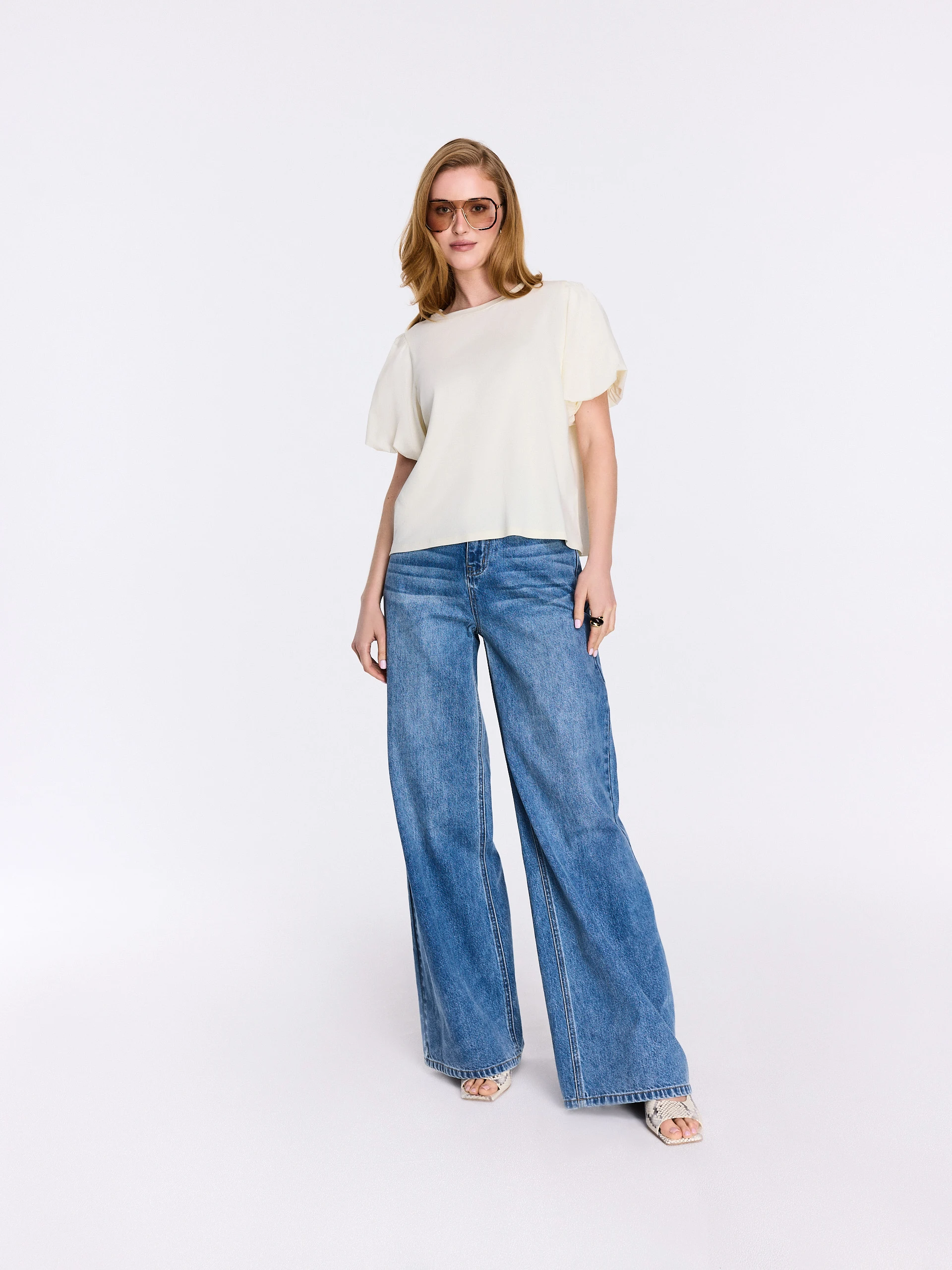 Cream-colored blouse with decorative sleeves