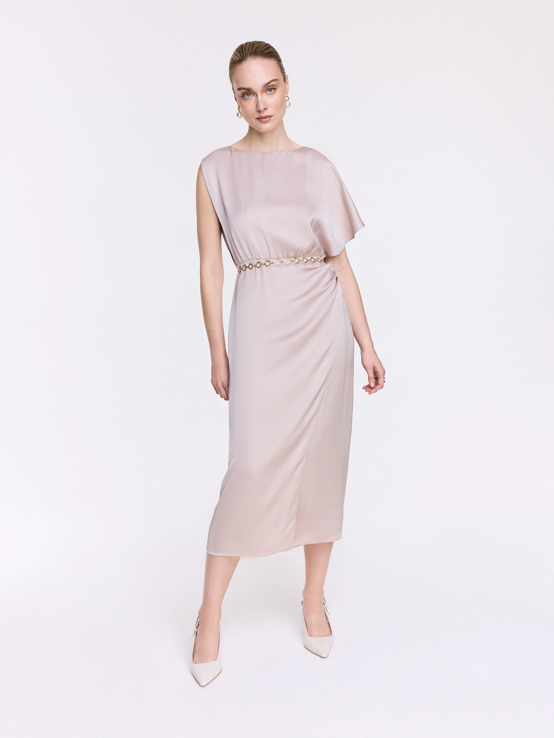 A glamorous dress with an asymmetrical sleeve
