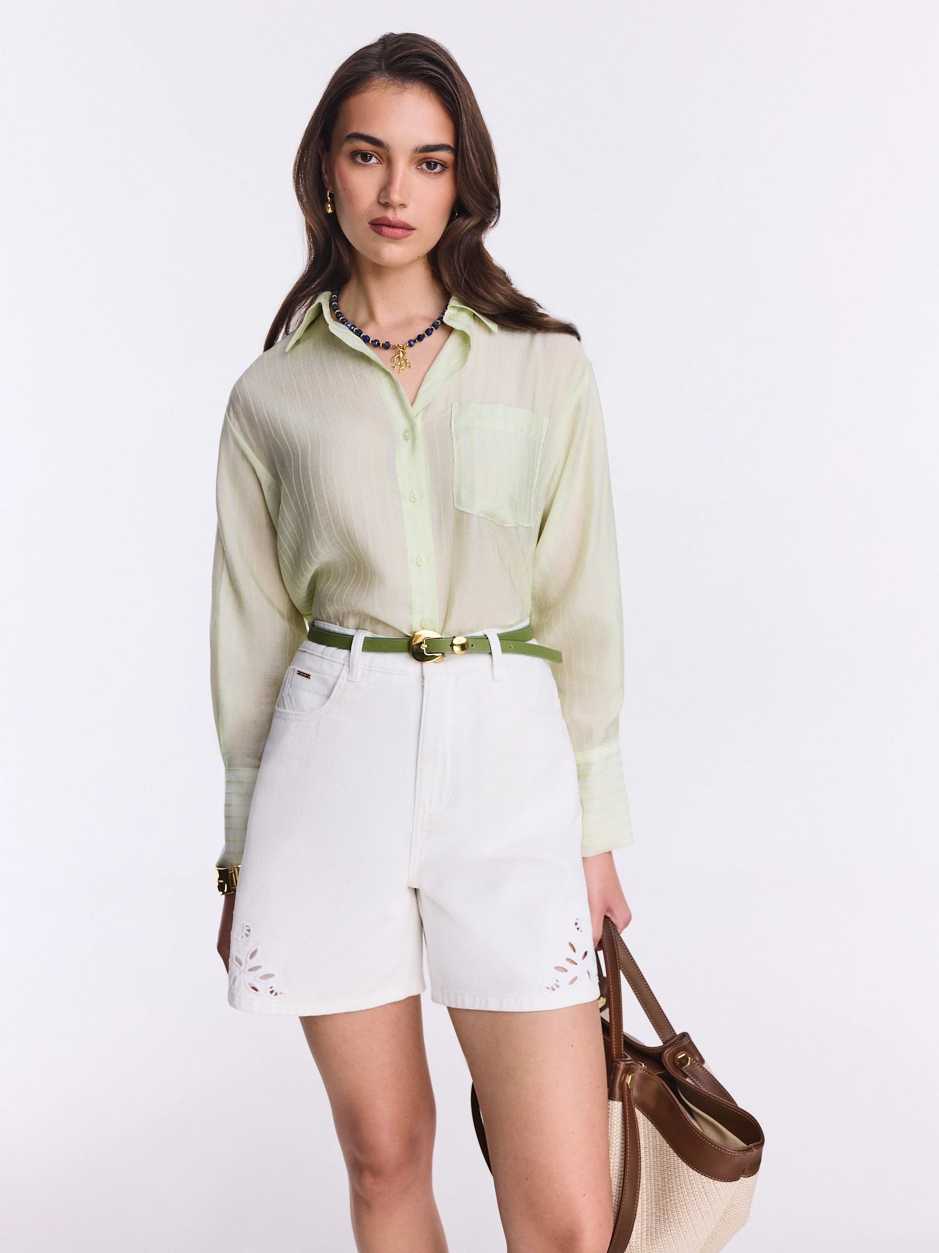 Short white denim pants with openwork decoration