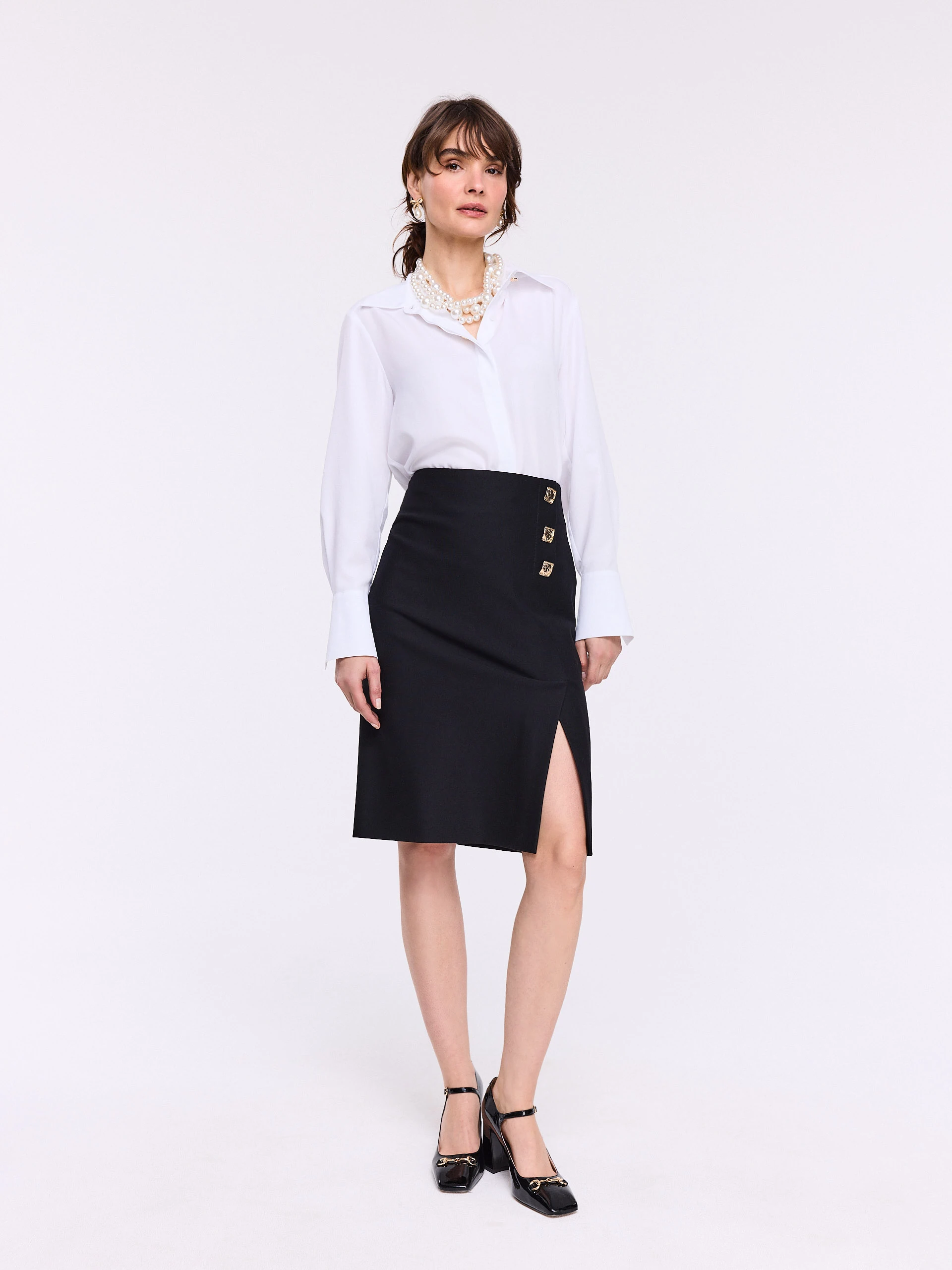 Black high-waisted skirt with decorative buttons