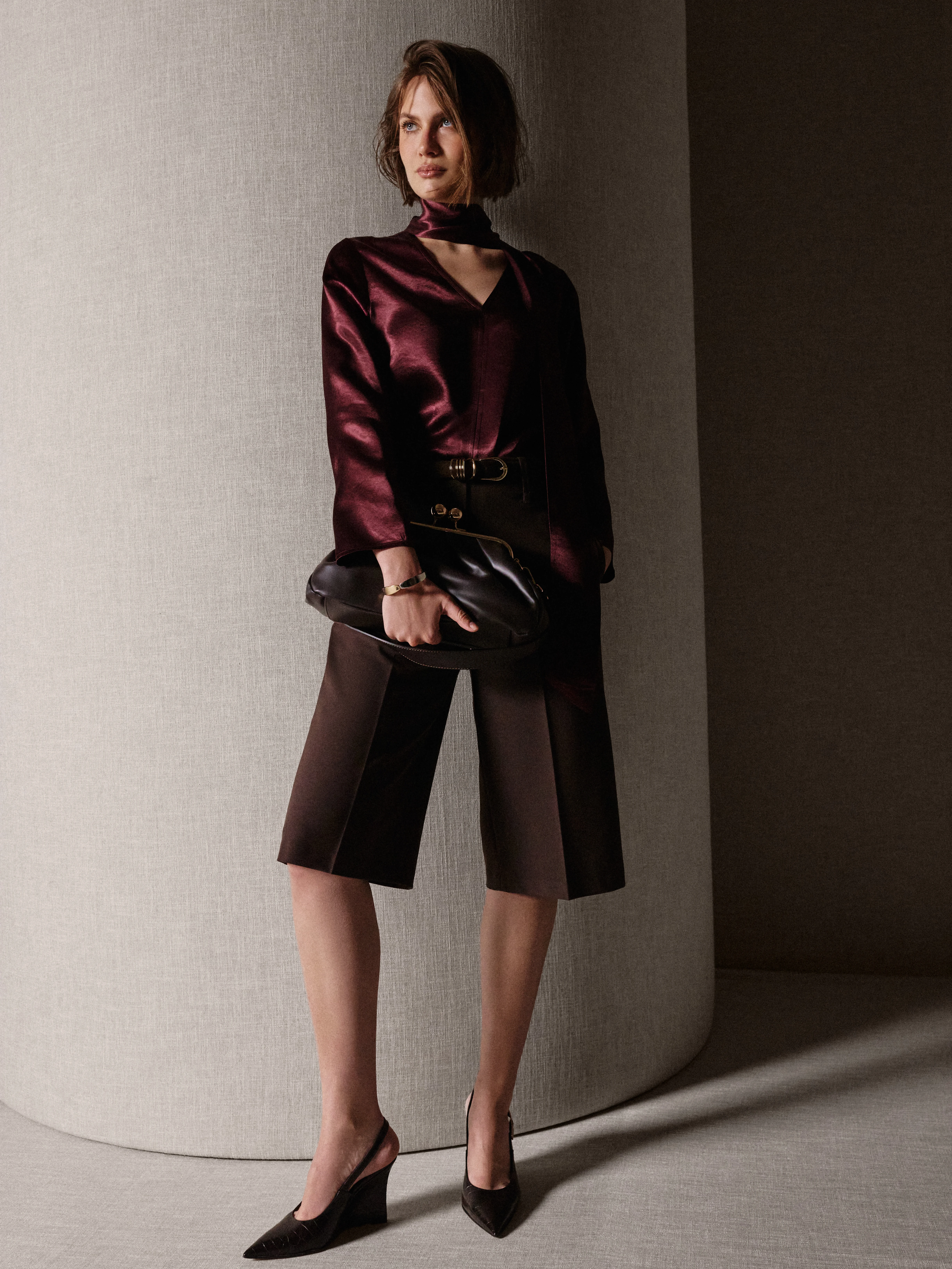 An elegant burgundy blouse with a sash
