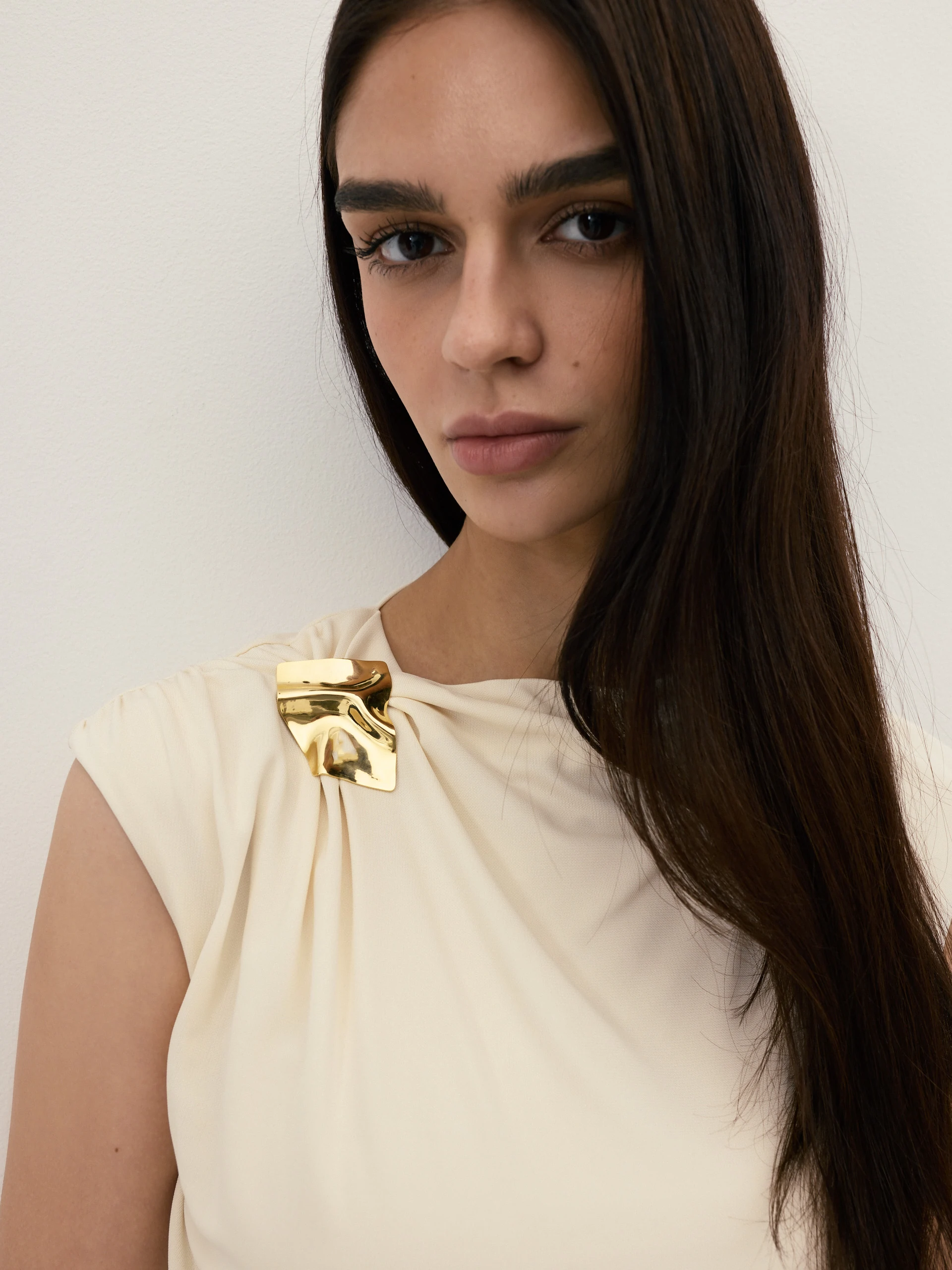 A cream-coloured viscose blouse with ruffles