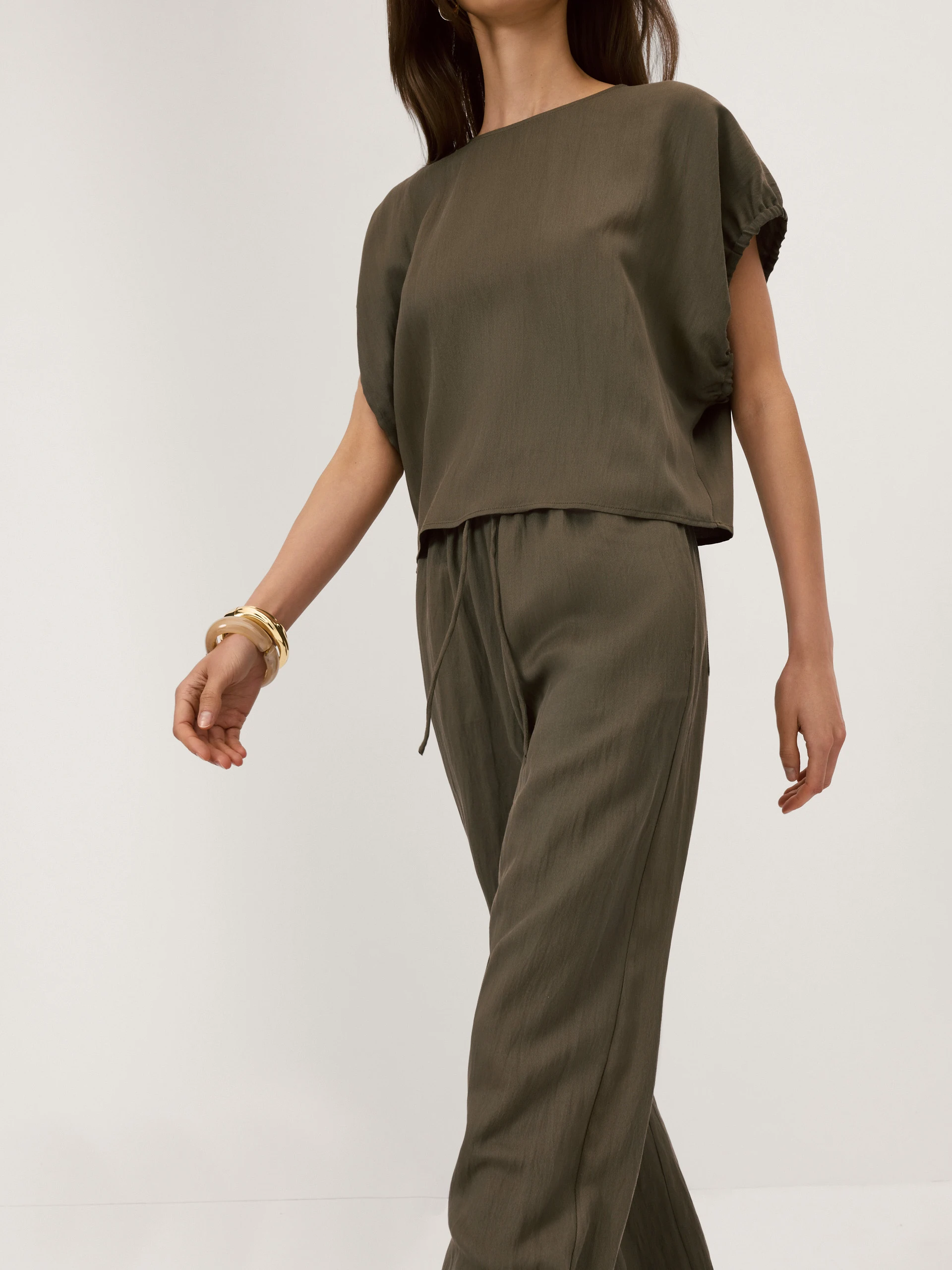 Olive-coloured blouse with a cut-out at the back