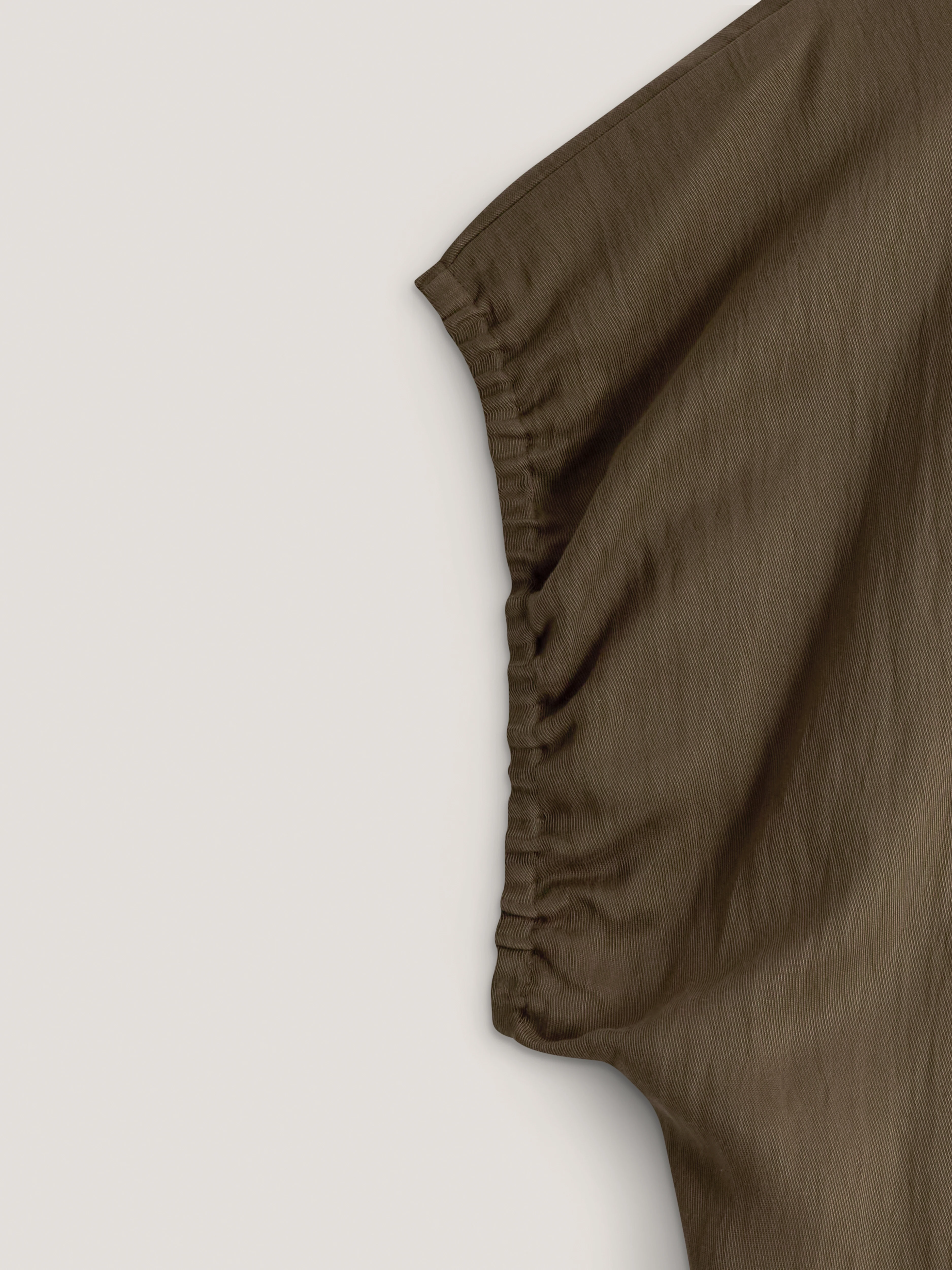 Olive-coloured blouse with a cut-out at the back