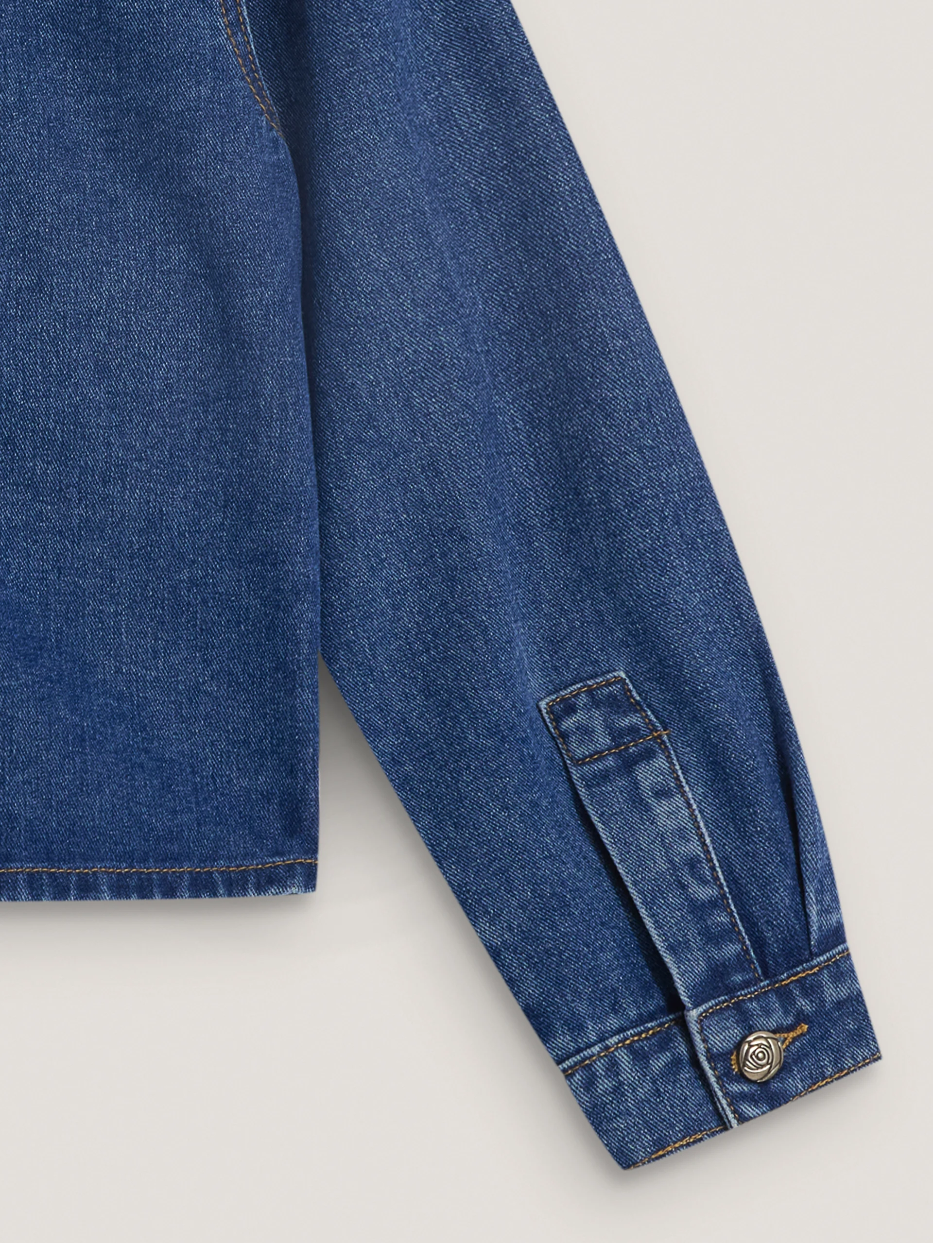 Denim jacket with decorative buttons