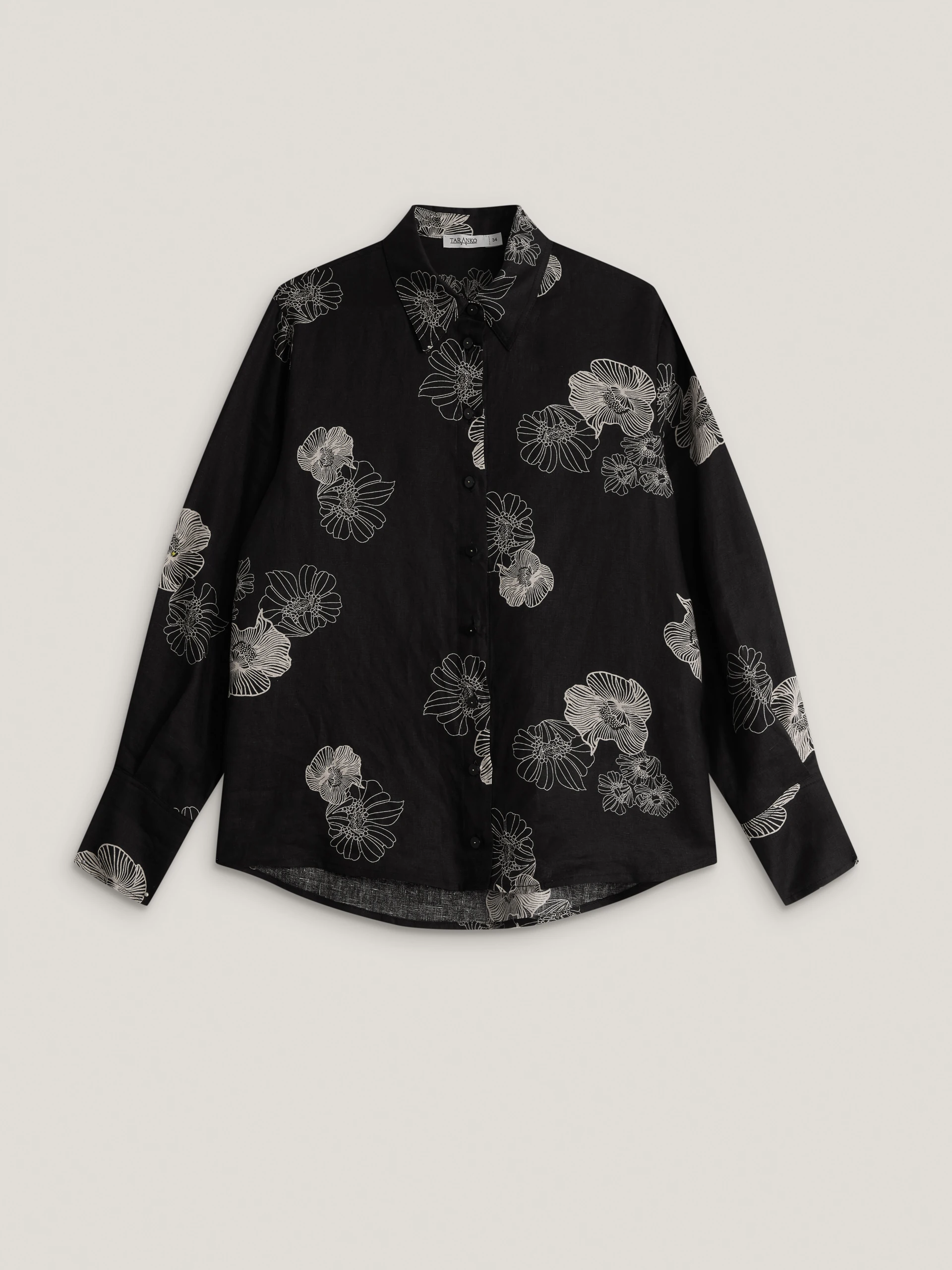 A black linen shirt with light-coloured floral print