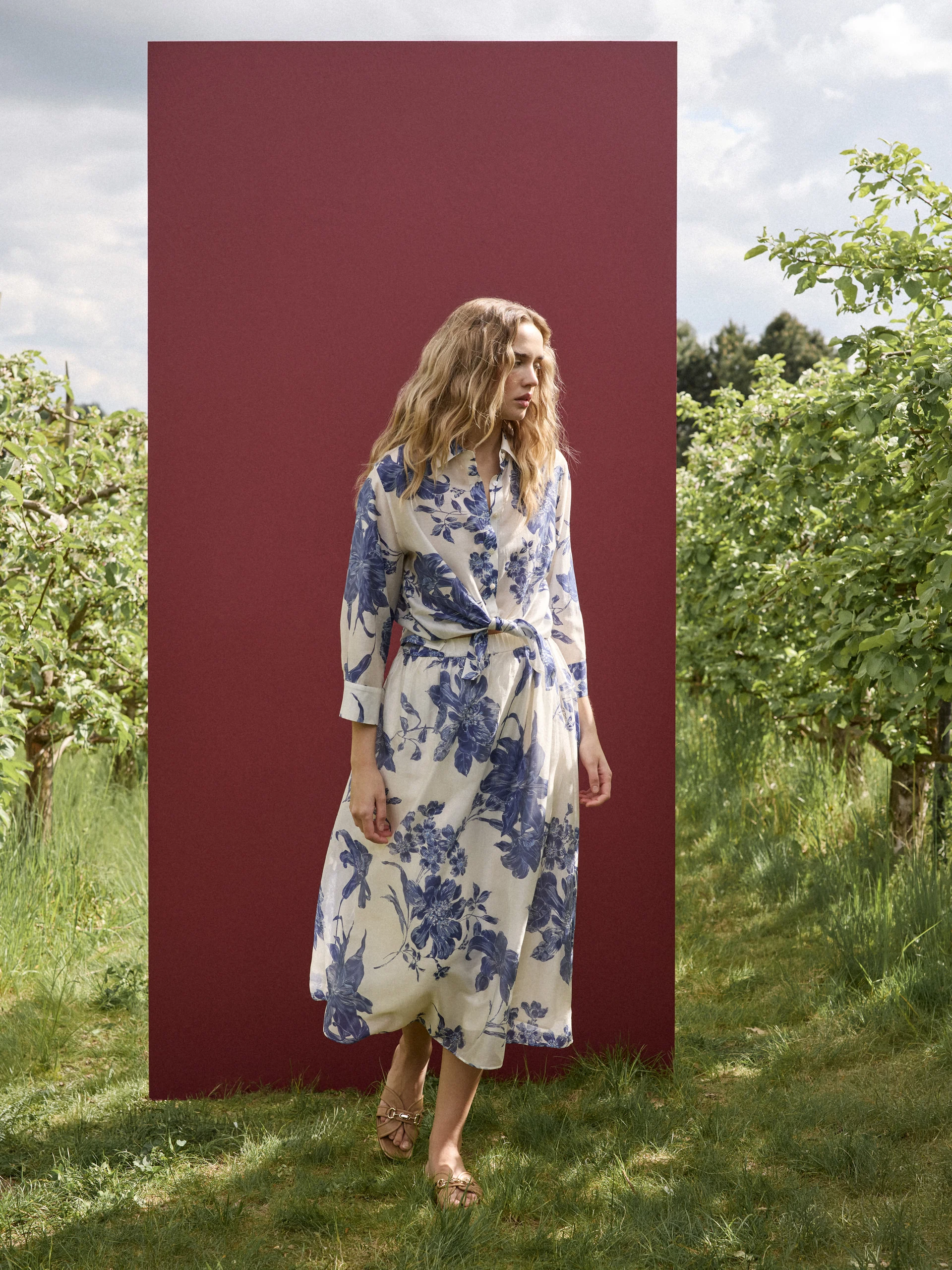 A cream-coloured, high-waisted skirt with navy blue floral print