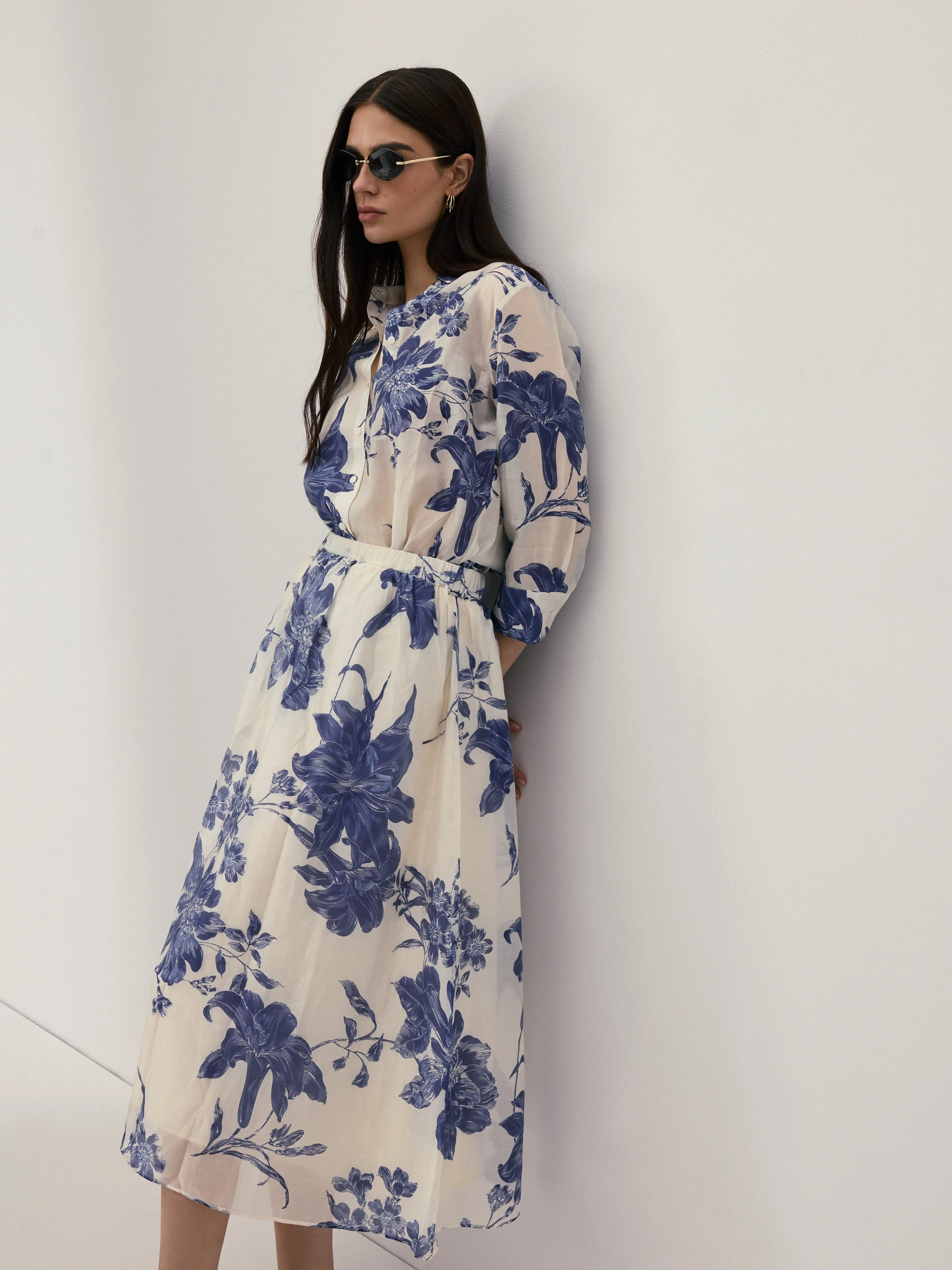 A cream-coloured, high-waisted skirt with navy blue floral print