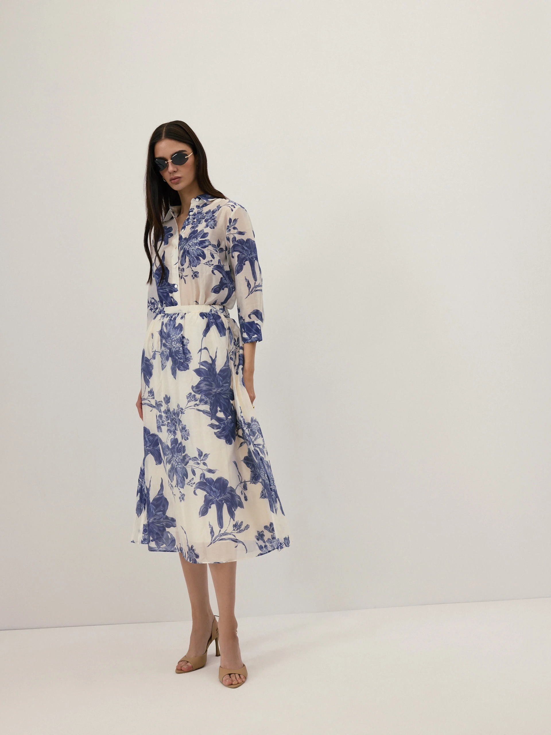 A cream-coloured, high-waisted skirt with navy blue floral print