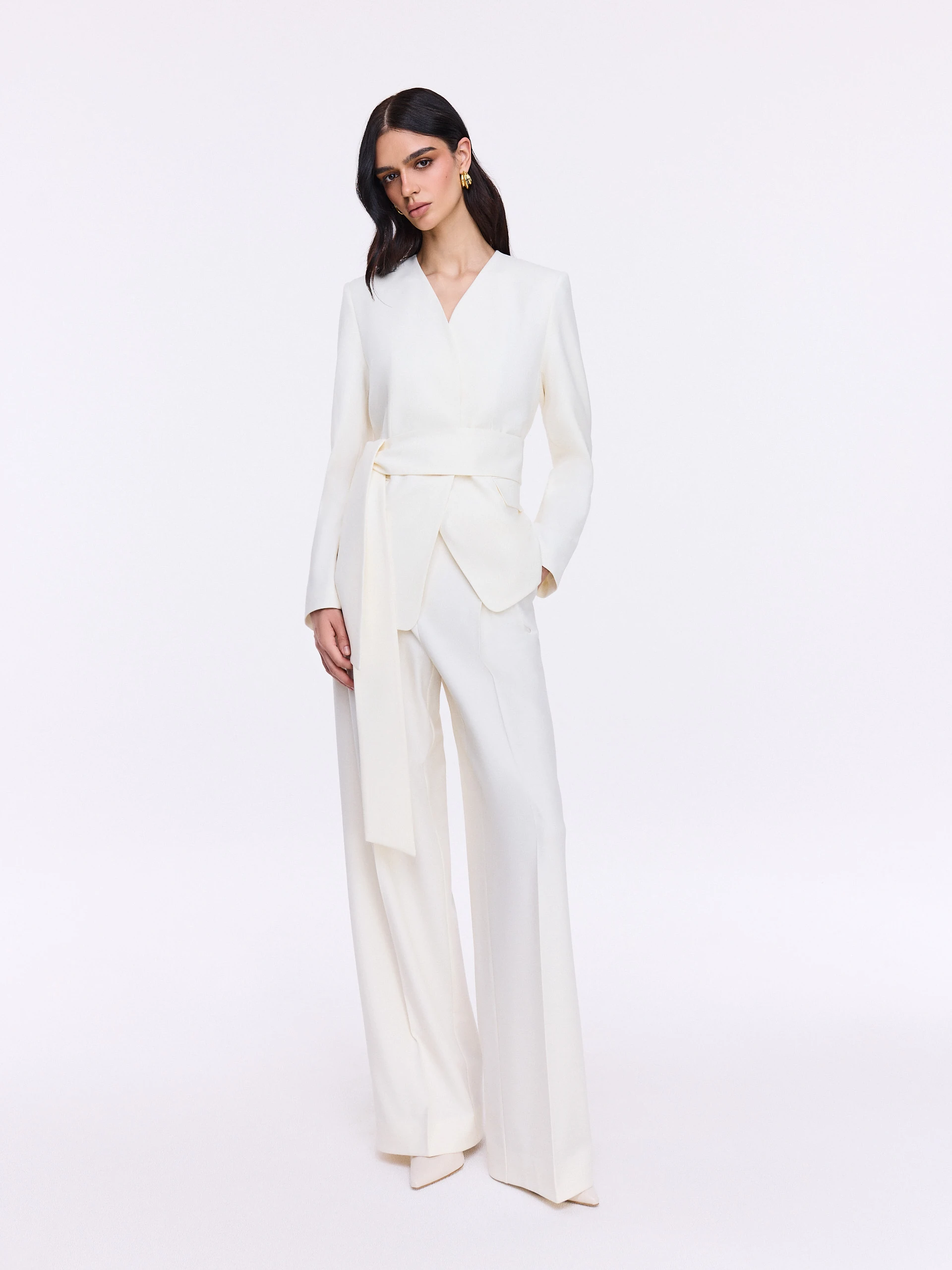 Elegant cream trousers with a gold button