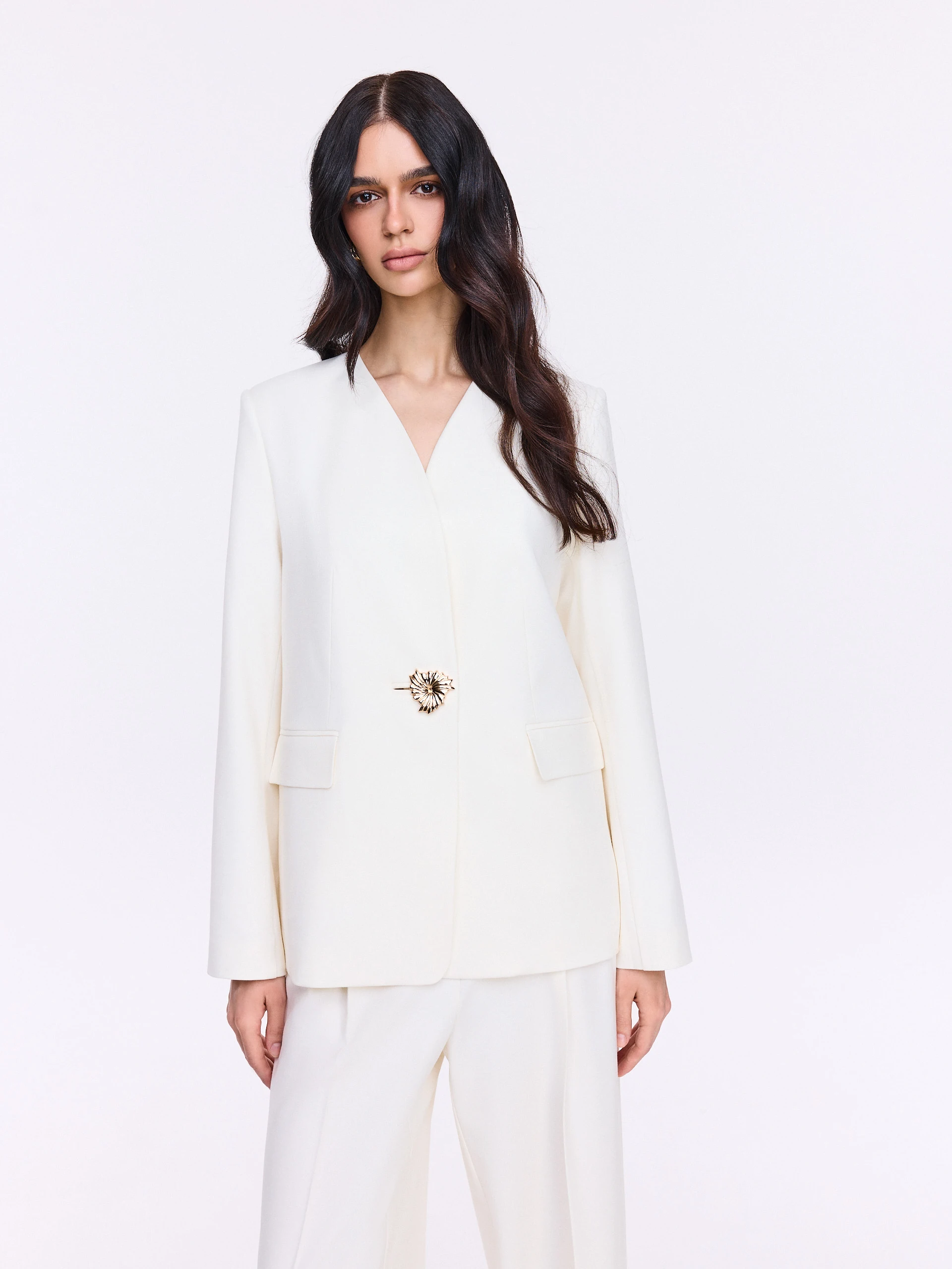 Cream jacket with decorative button and sash