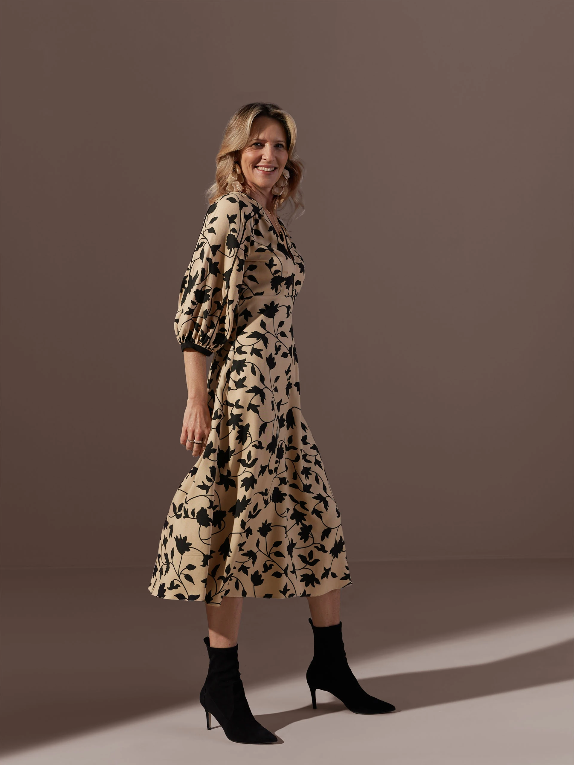 Beige dress with black leaves print