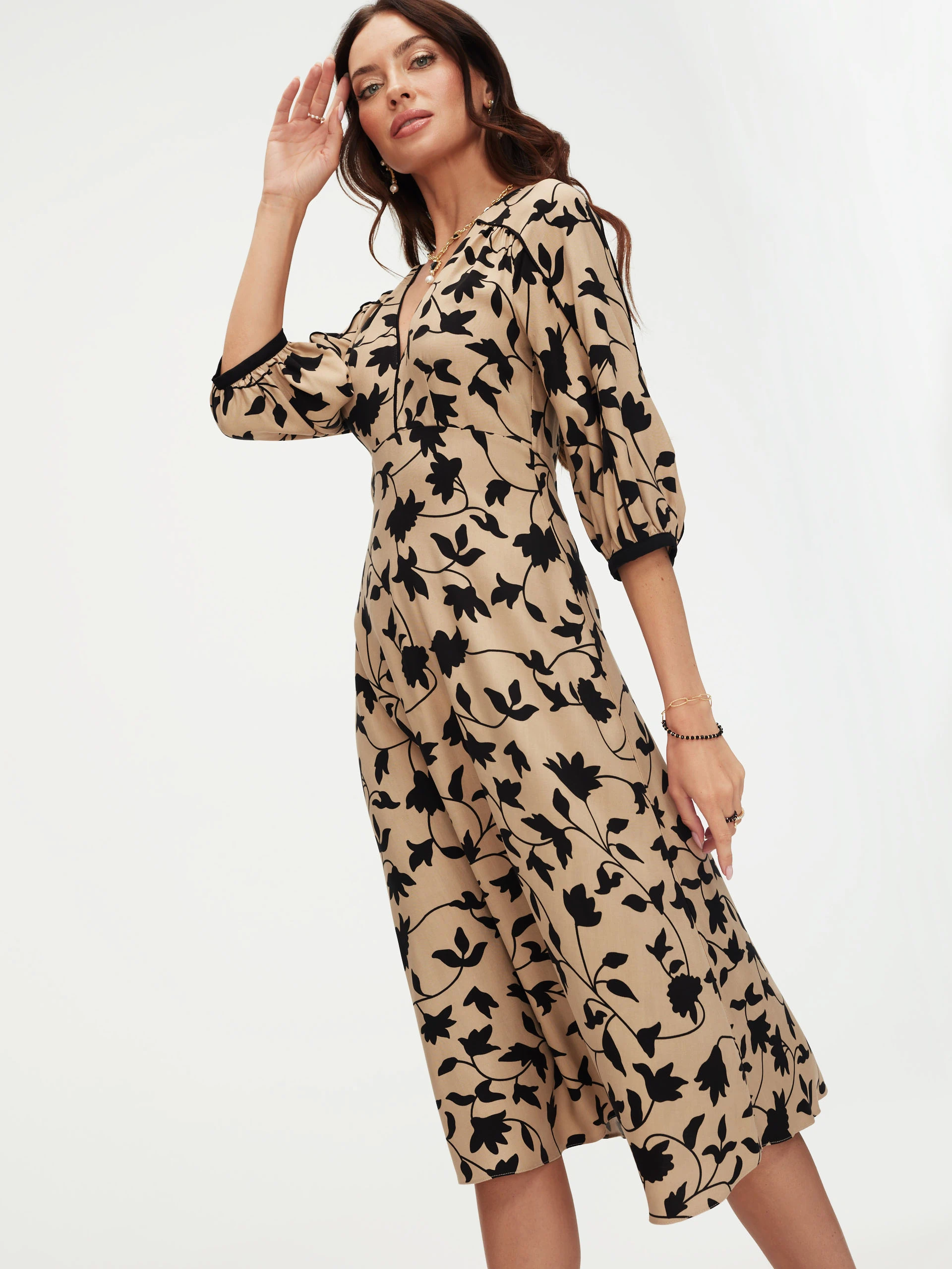 Beige dress with black leaves print