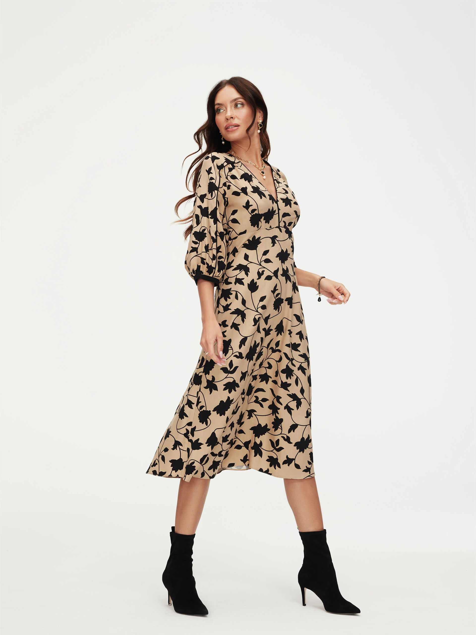 Beige dress with black leaves print