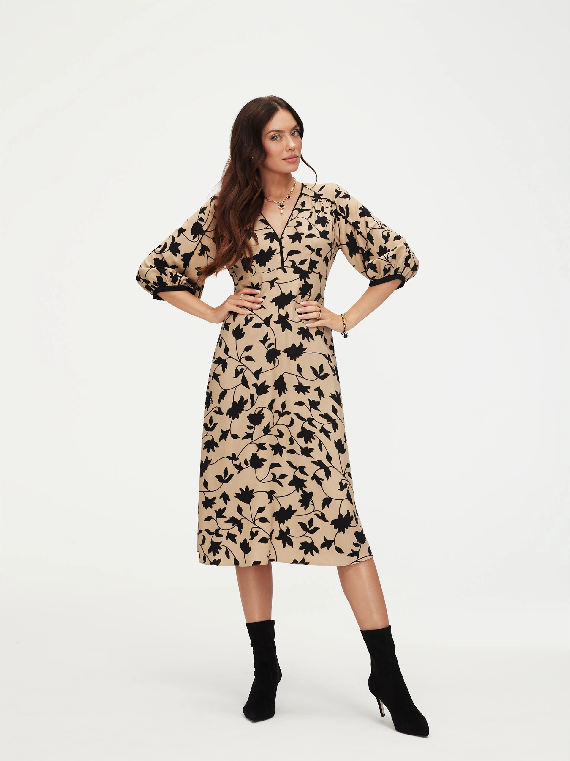 Beige dress with black leaves print