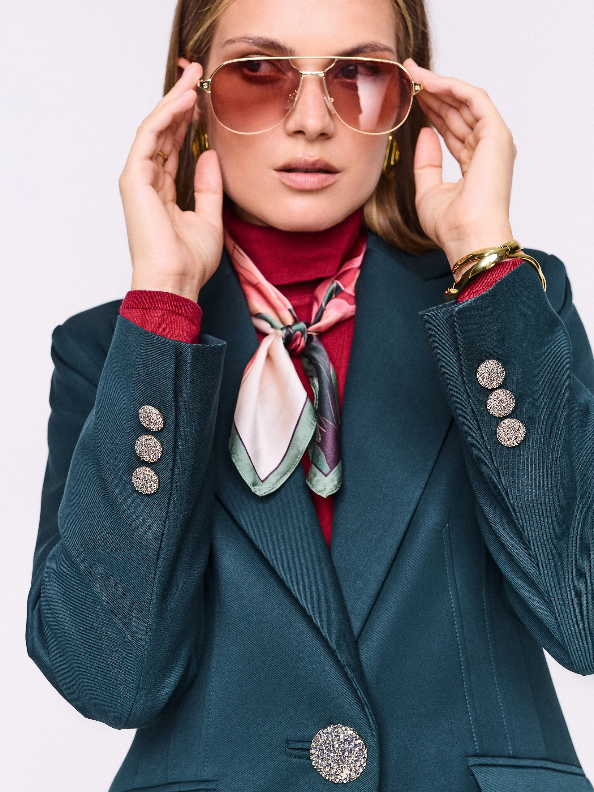 Dark green fitted jacket with decorative button