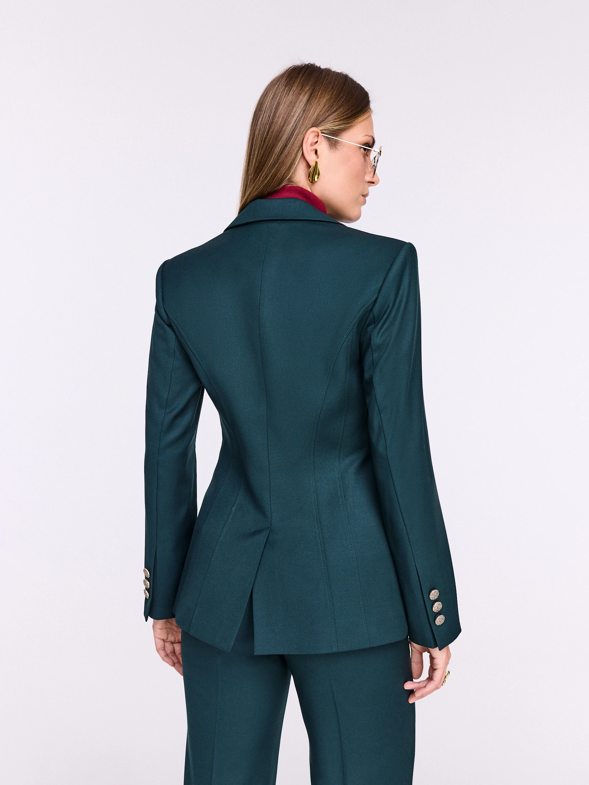 Dark green fitted jacket with decorative button