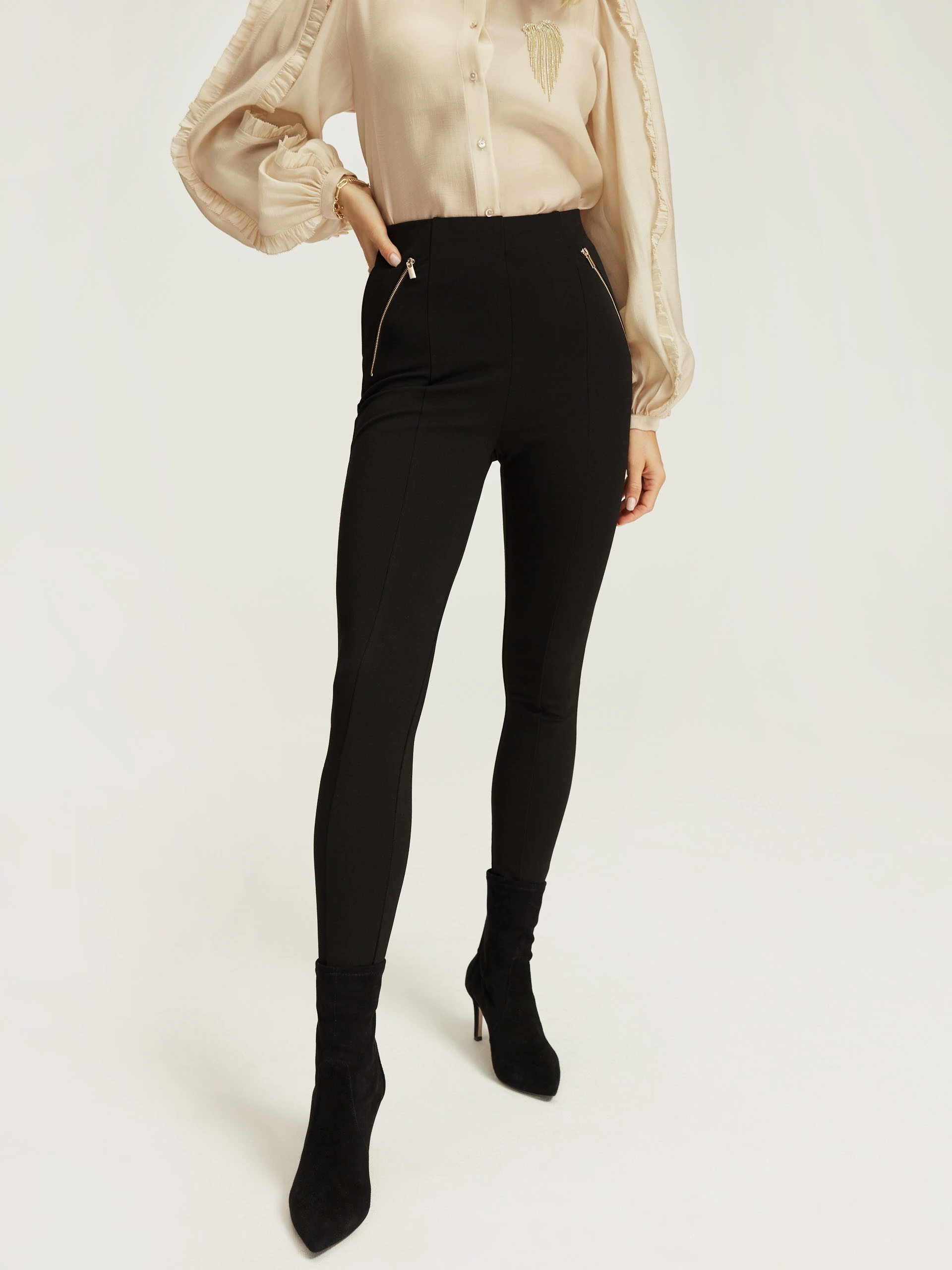 Black fitted pants with zippers