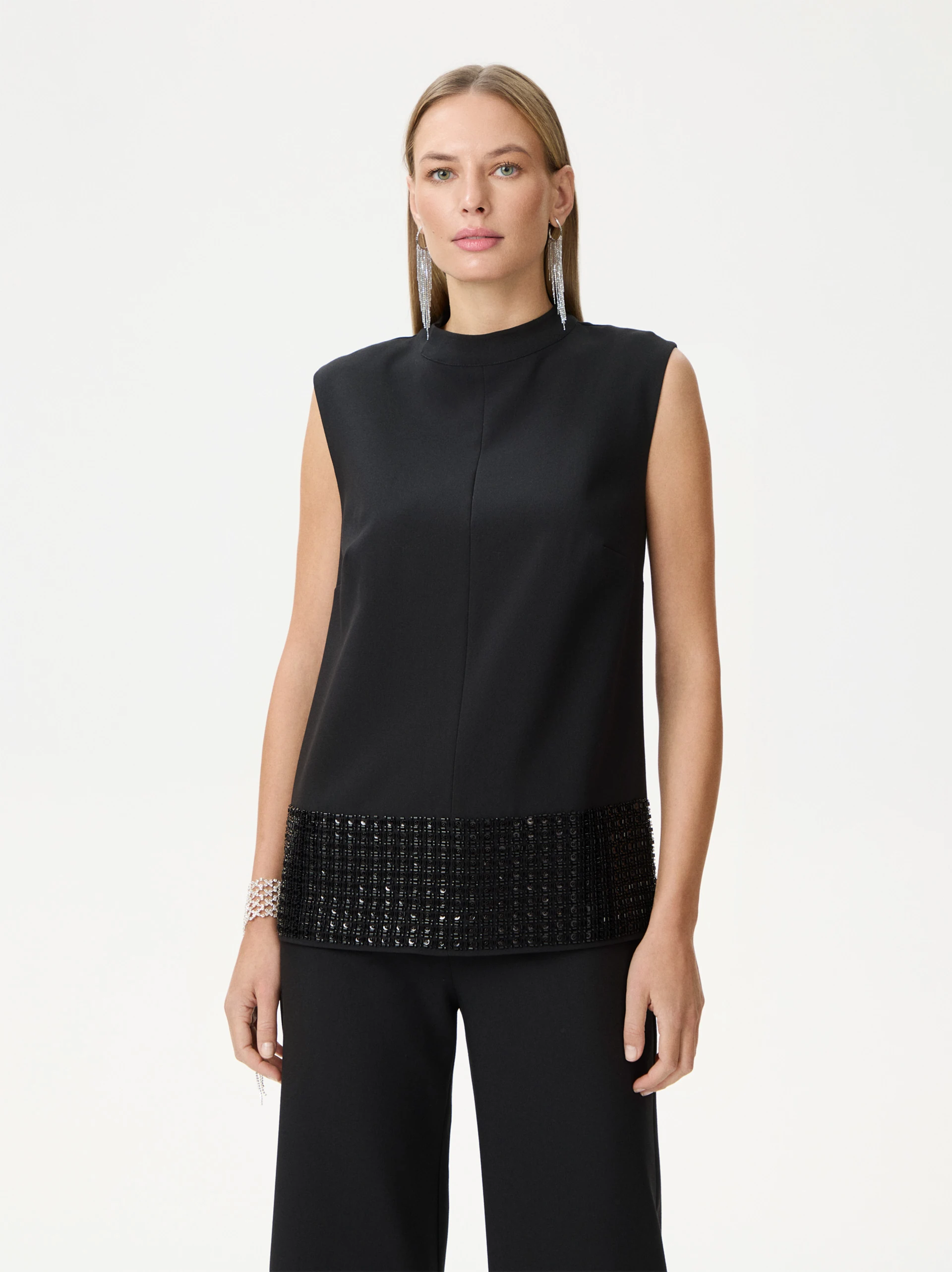 Black sleeveless blouse with decorative trim