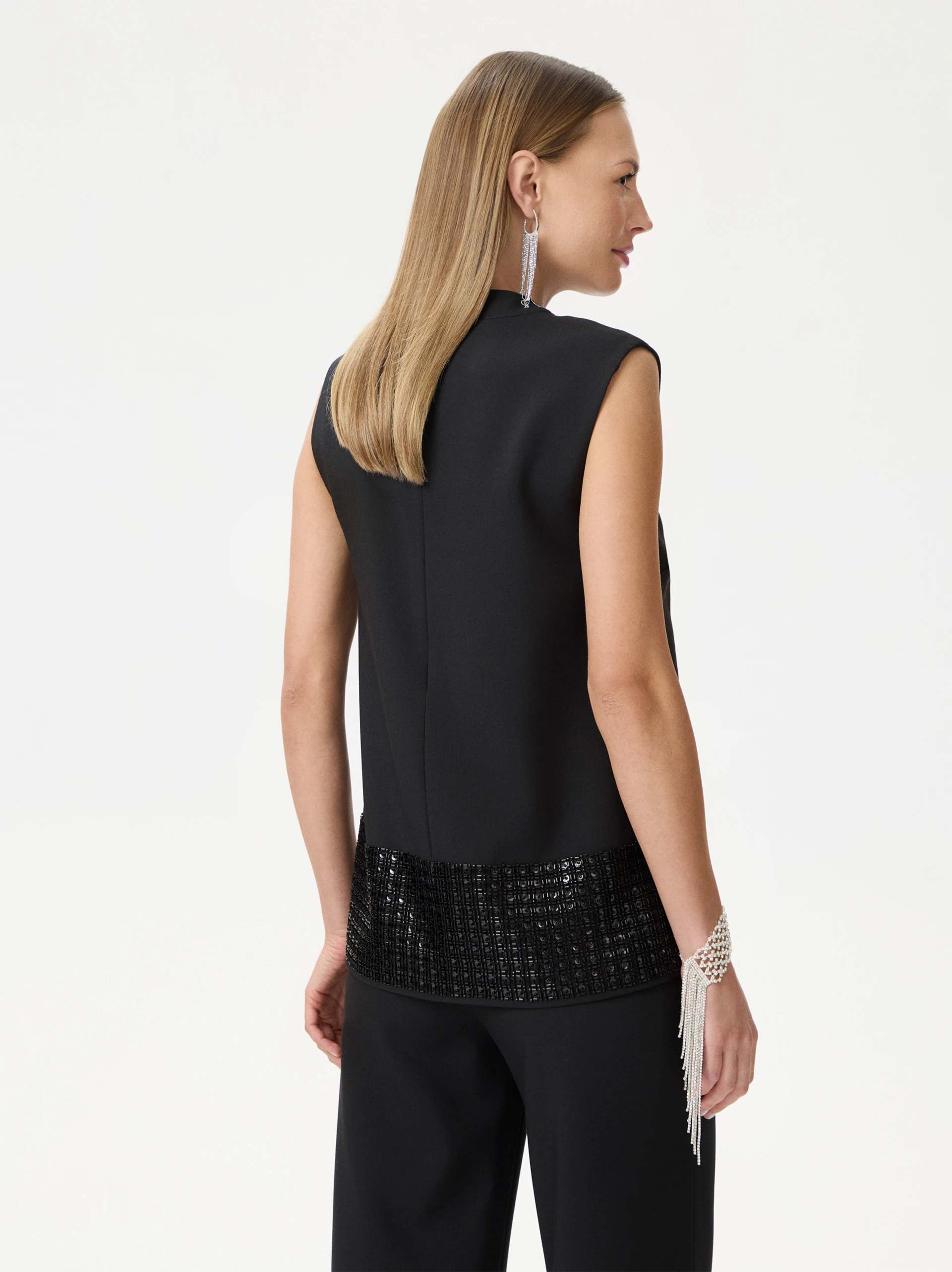 Black sleeveless blouse with decorative trim