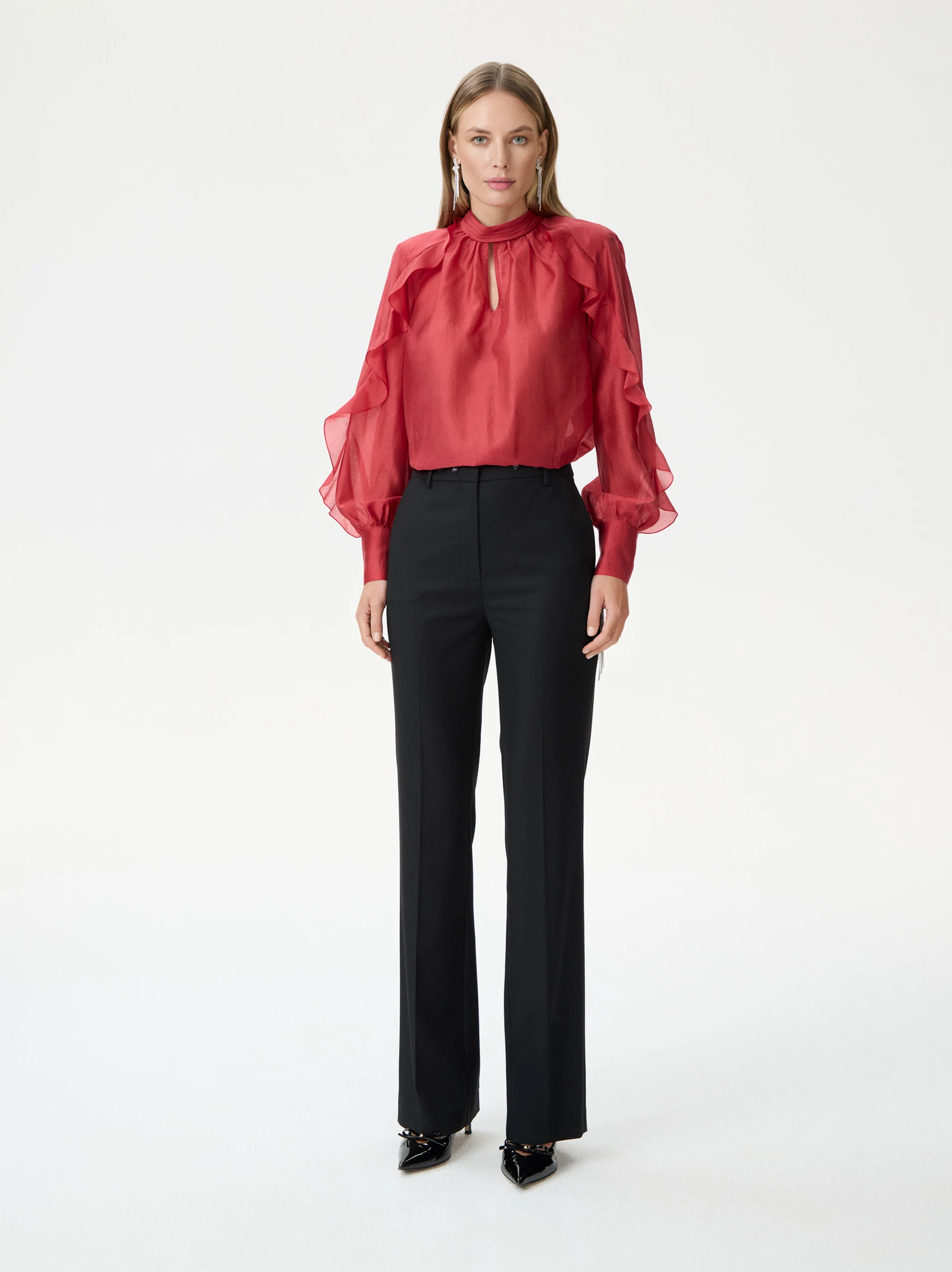 Black high-waisted pants decorated with rivets