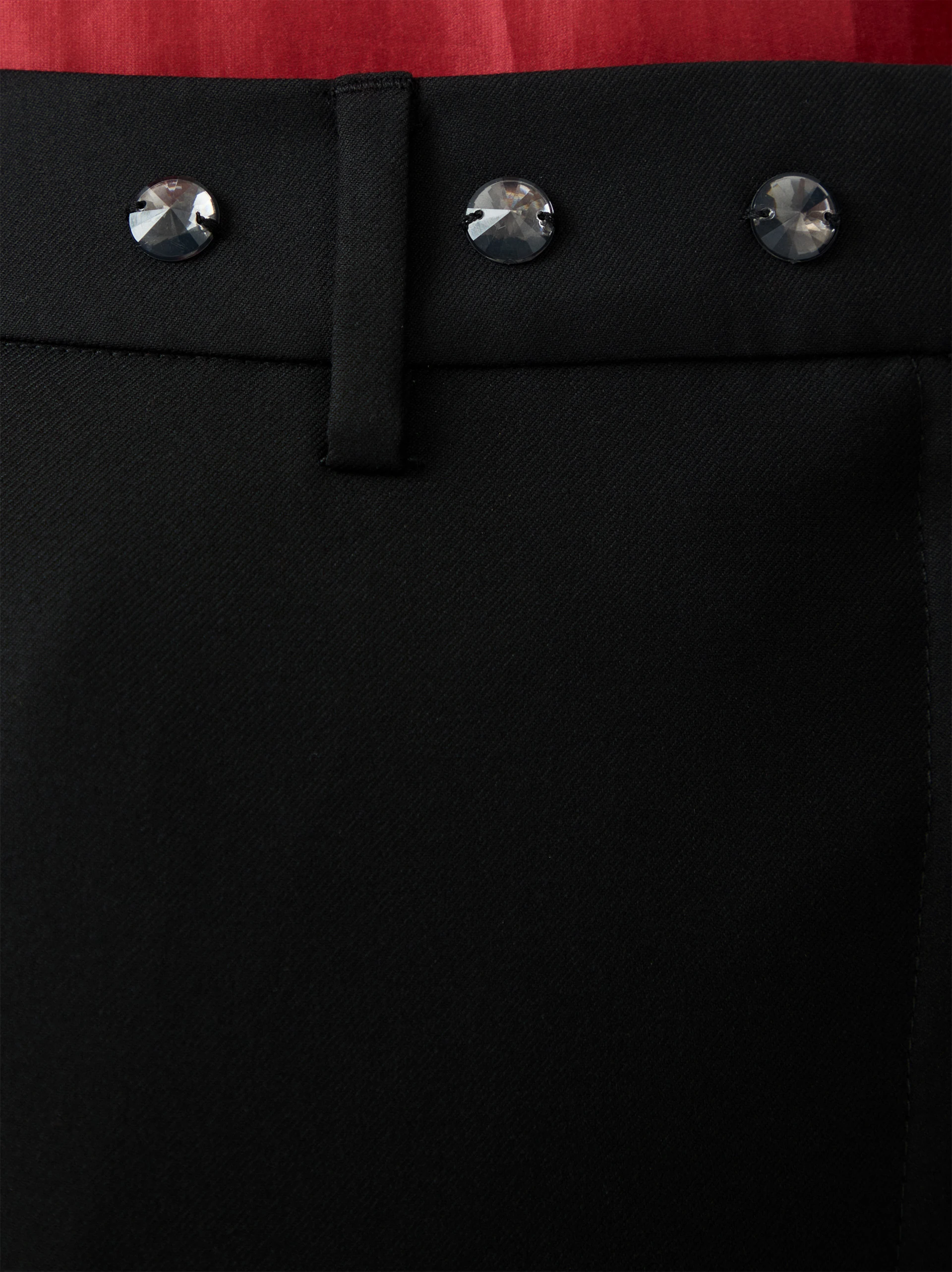Black high-waisted pants decorated with rivets