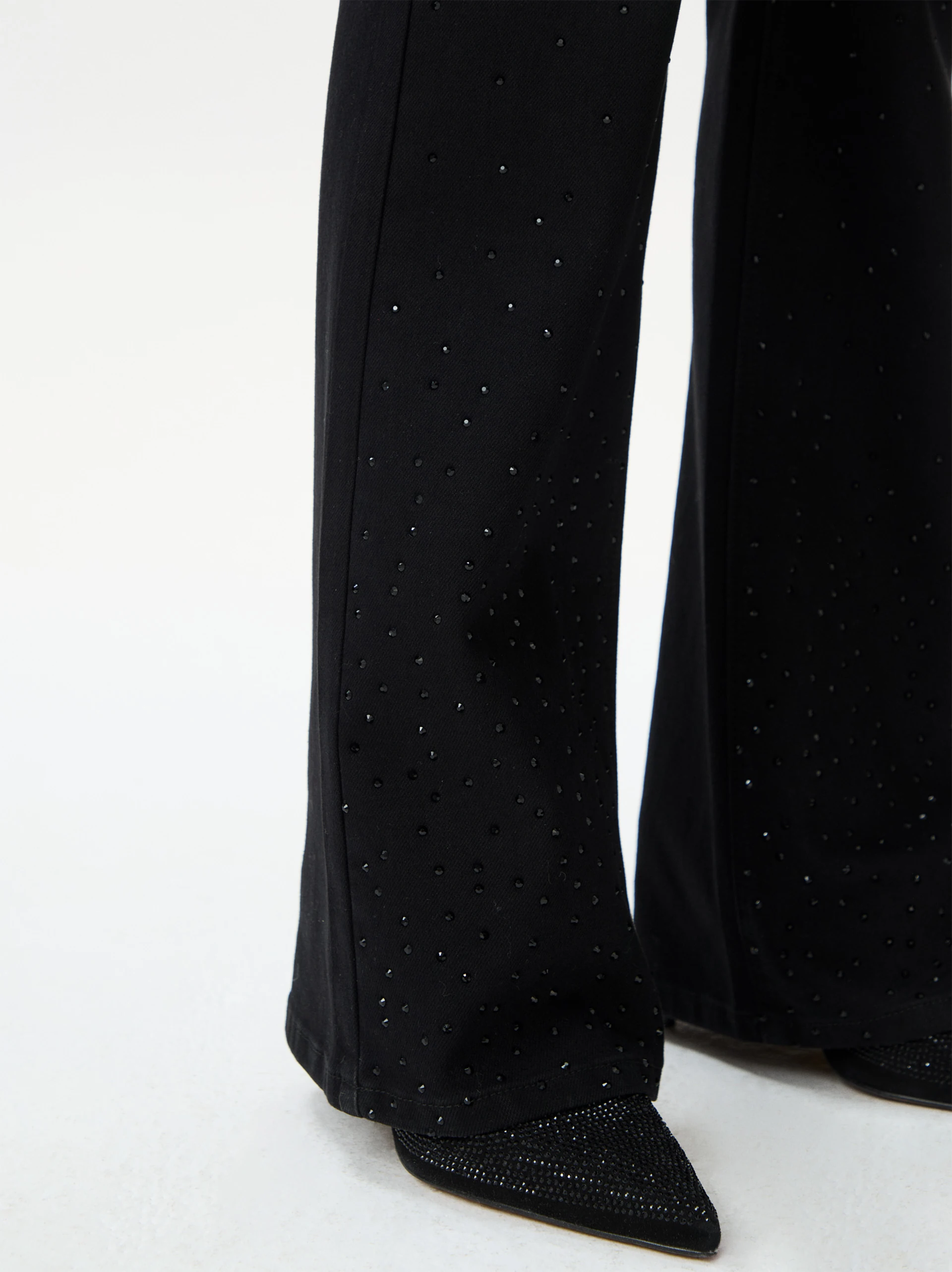 Black bell-bottom pants with shiny detail
