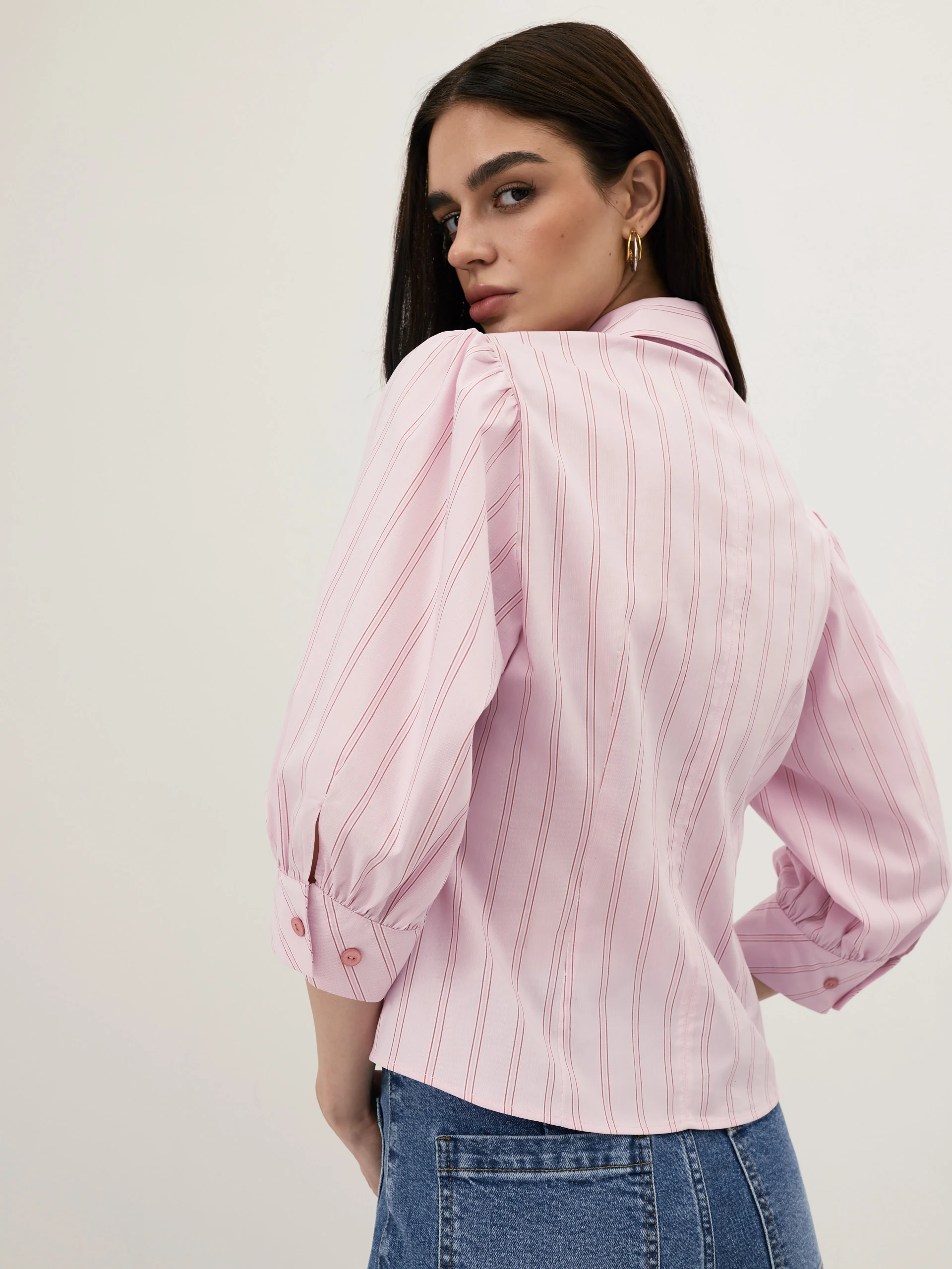 A light pink, fitted, ribbed blouse