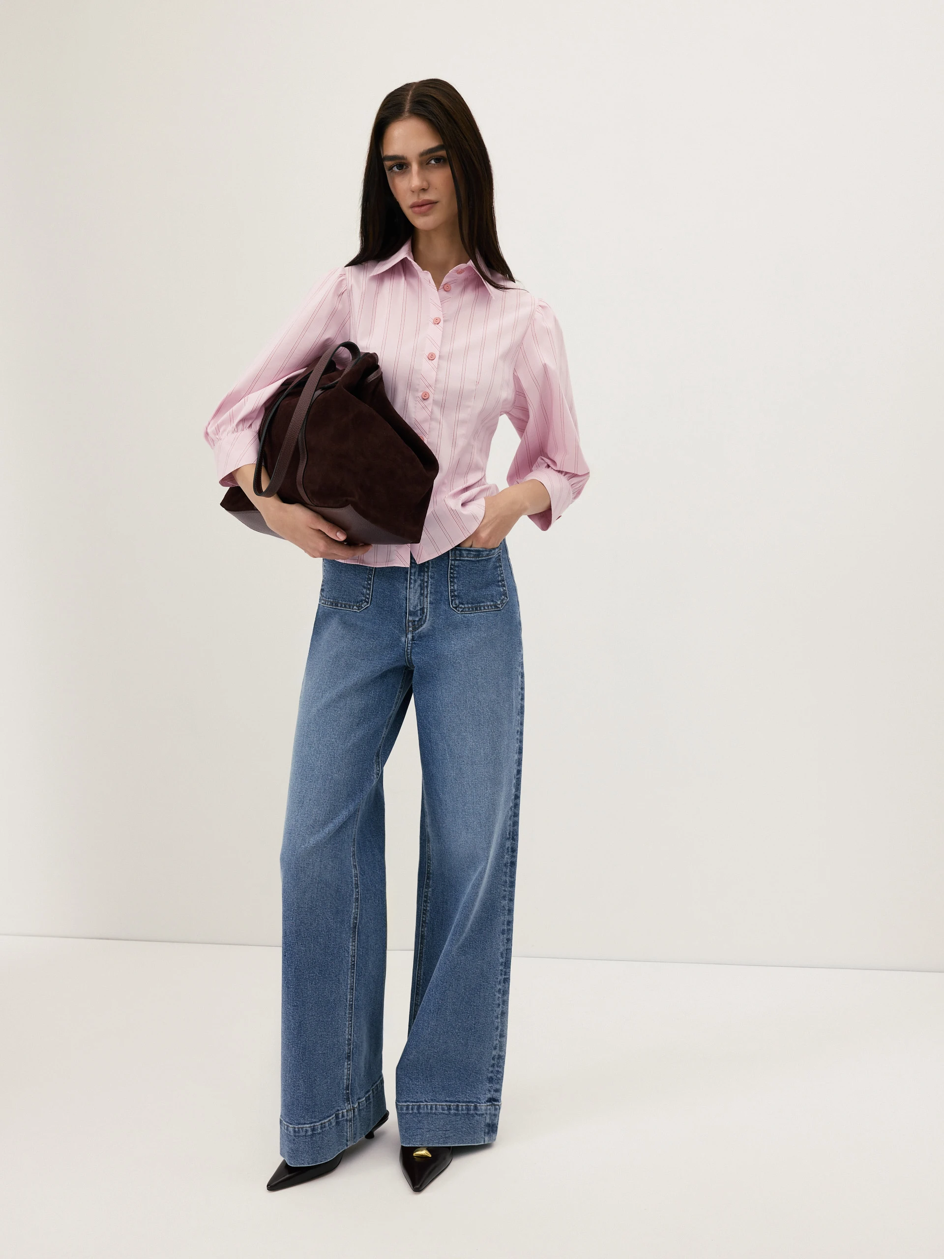 A light pink, fitted, ribbed blouse