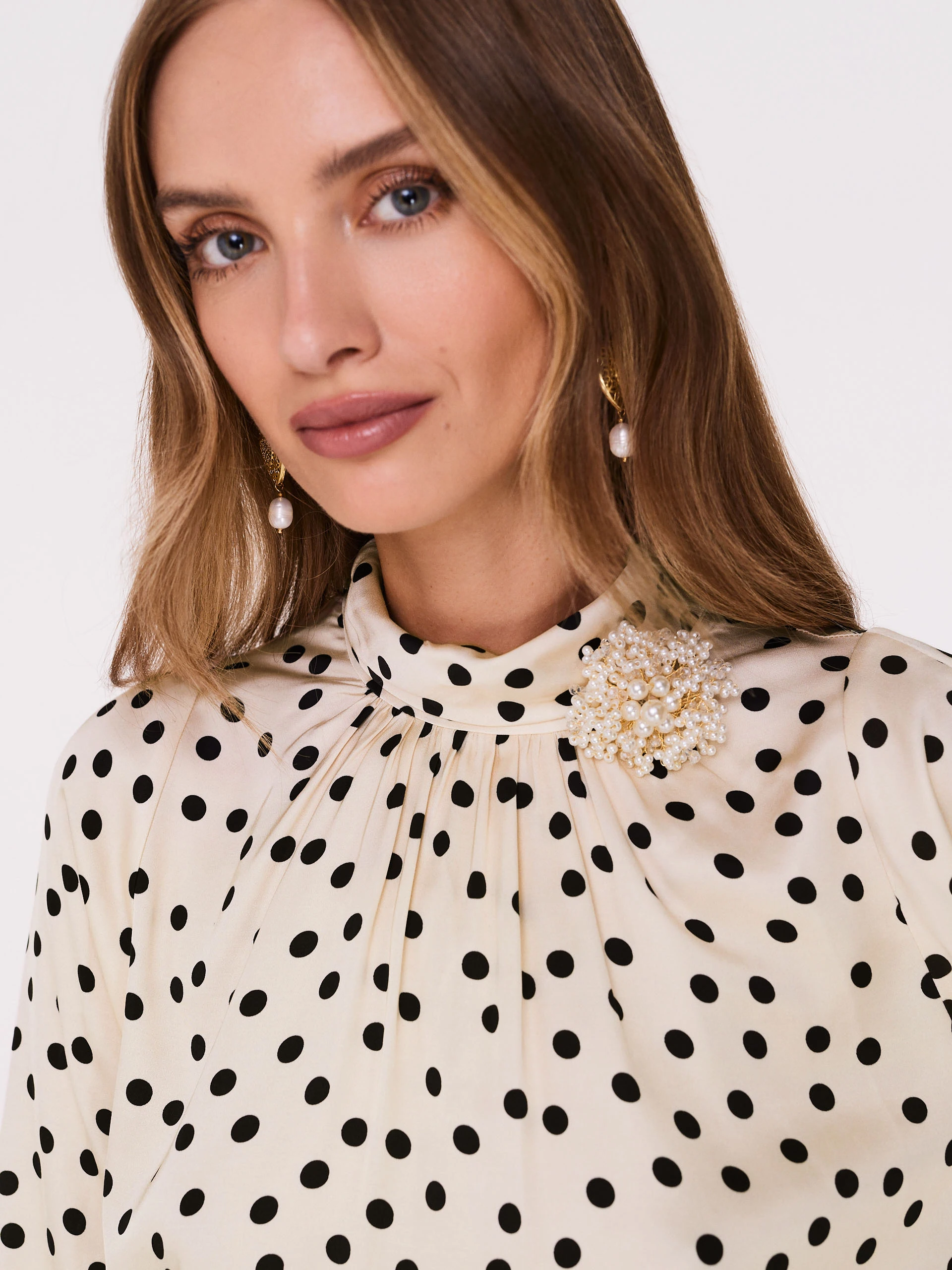Cream pea blouse with pearl brooch